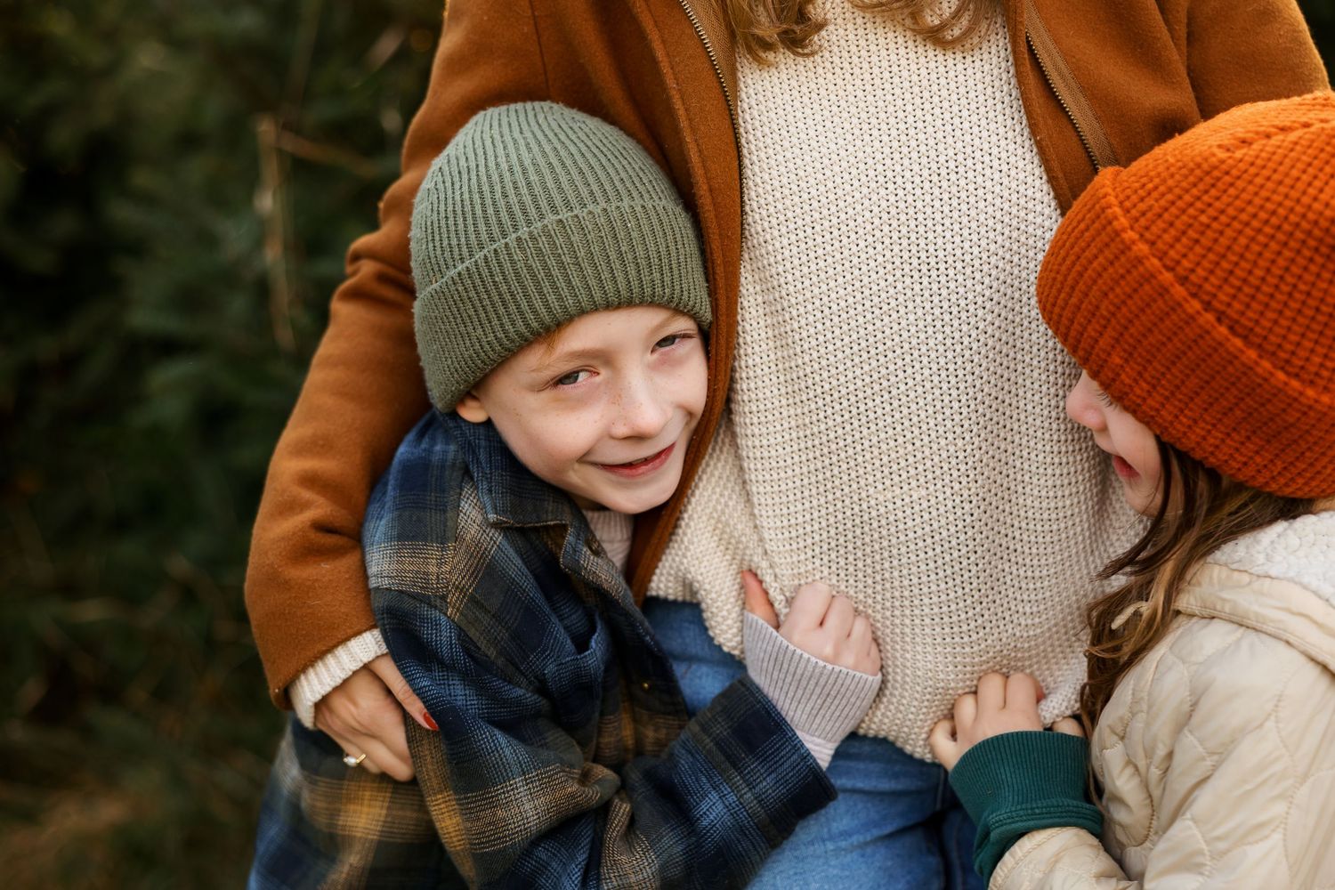 Two people wearing colorful winter beanies share a joyful moment in warm autumn clothing.