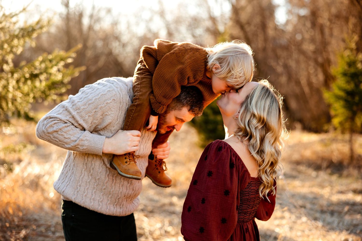 Intimate family moment captured in golden hour lighting outdoors.
