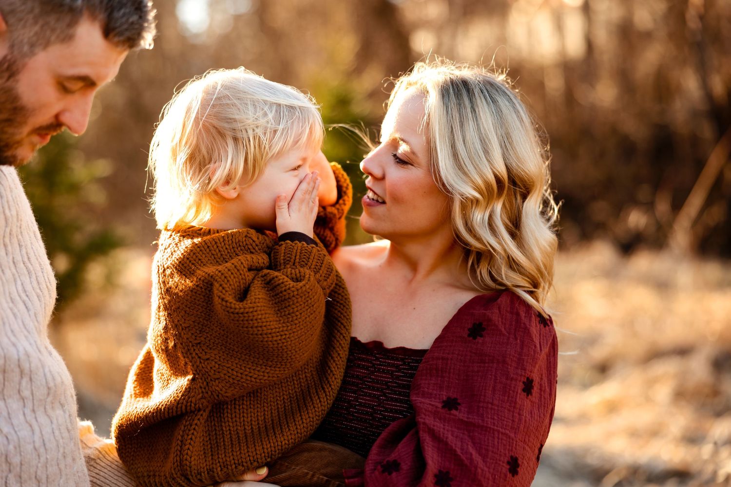 Sweet family interaction captured in warm autumn sunlight.