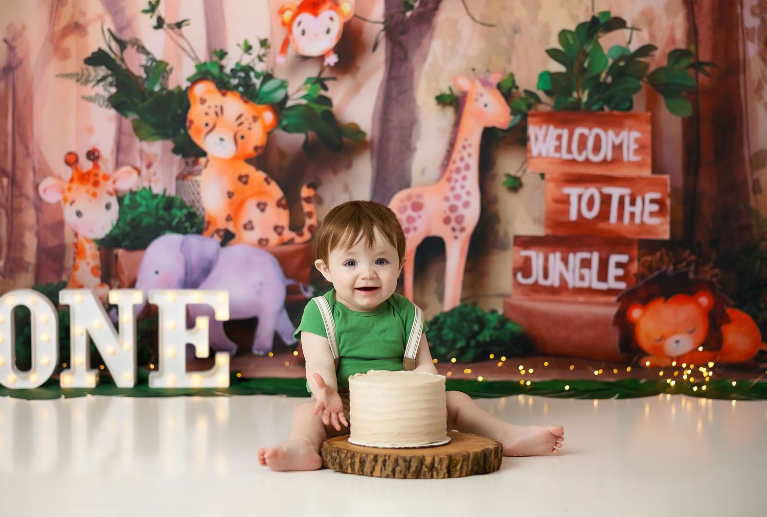 Safari themed birthday party backdrop with jungle animals and wooden decorations.