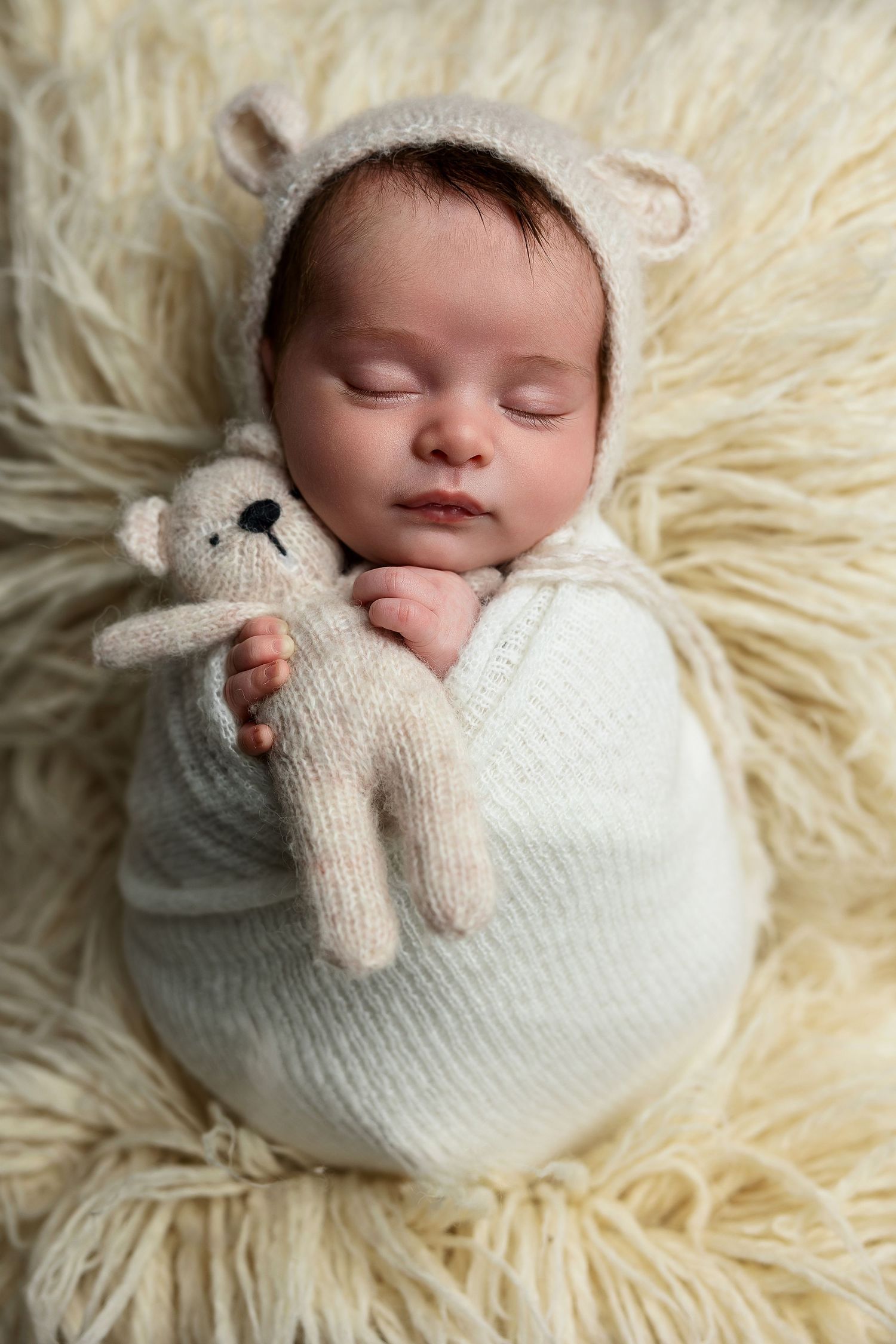 Newborn baby wrapped in neutral blanket during Brantford photo session