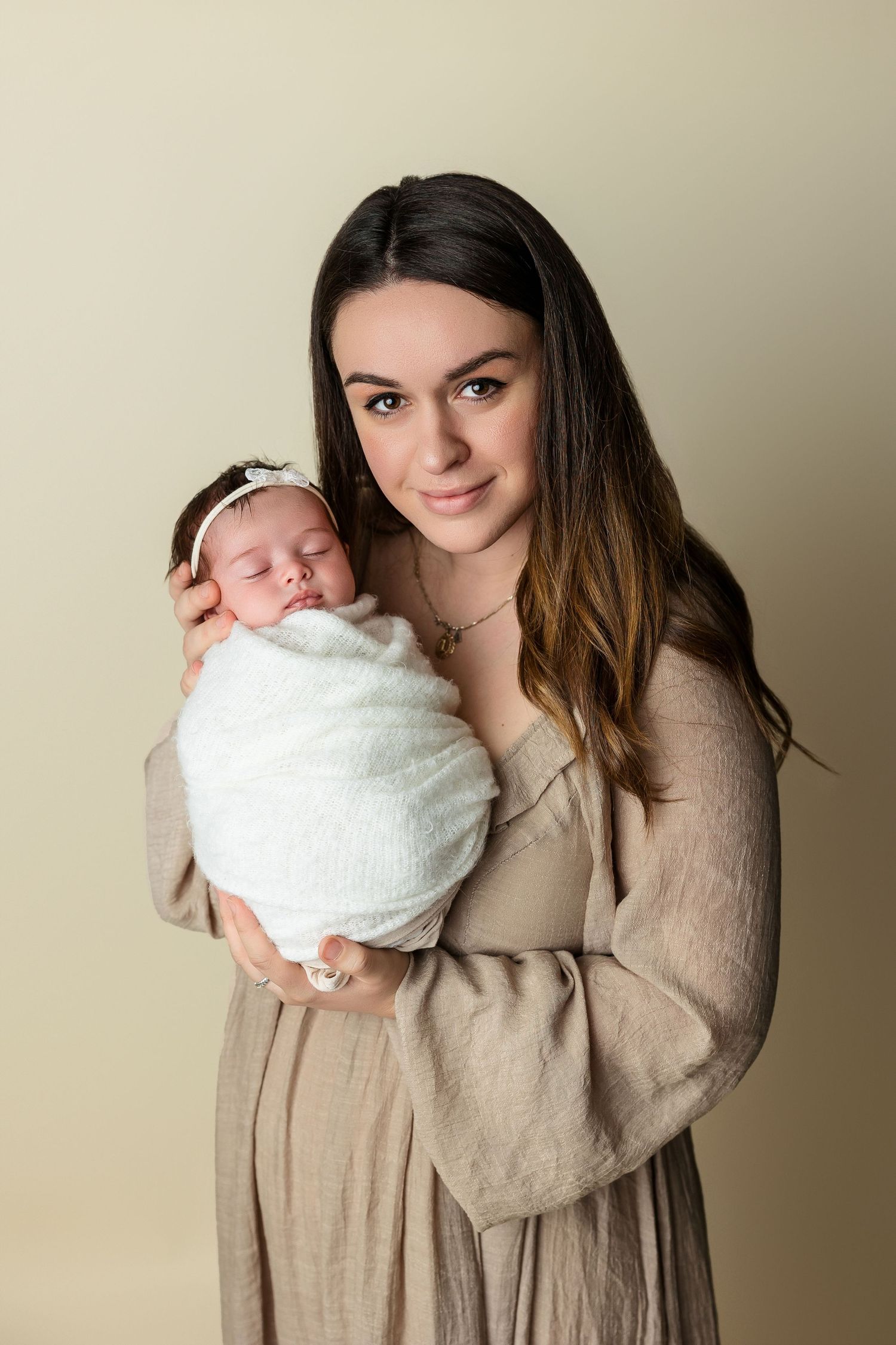 Natural newborn photography with parents in soft neutral tones