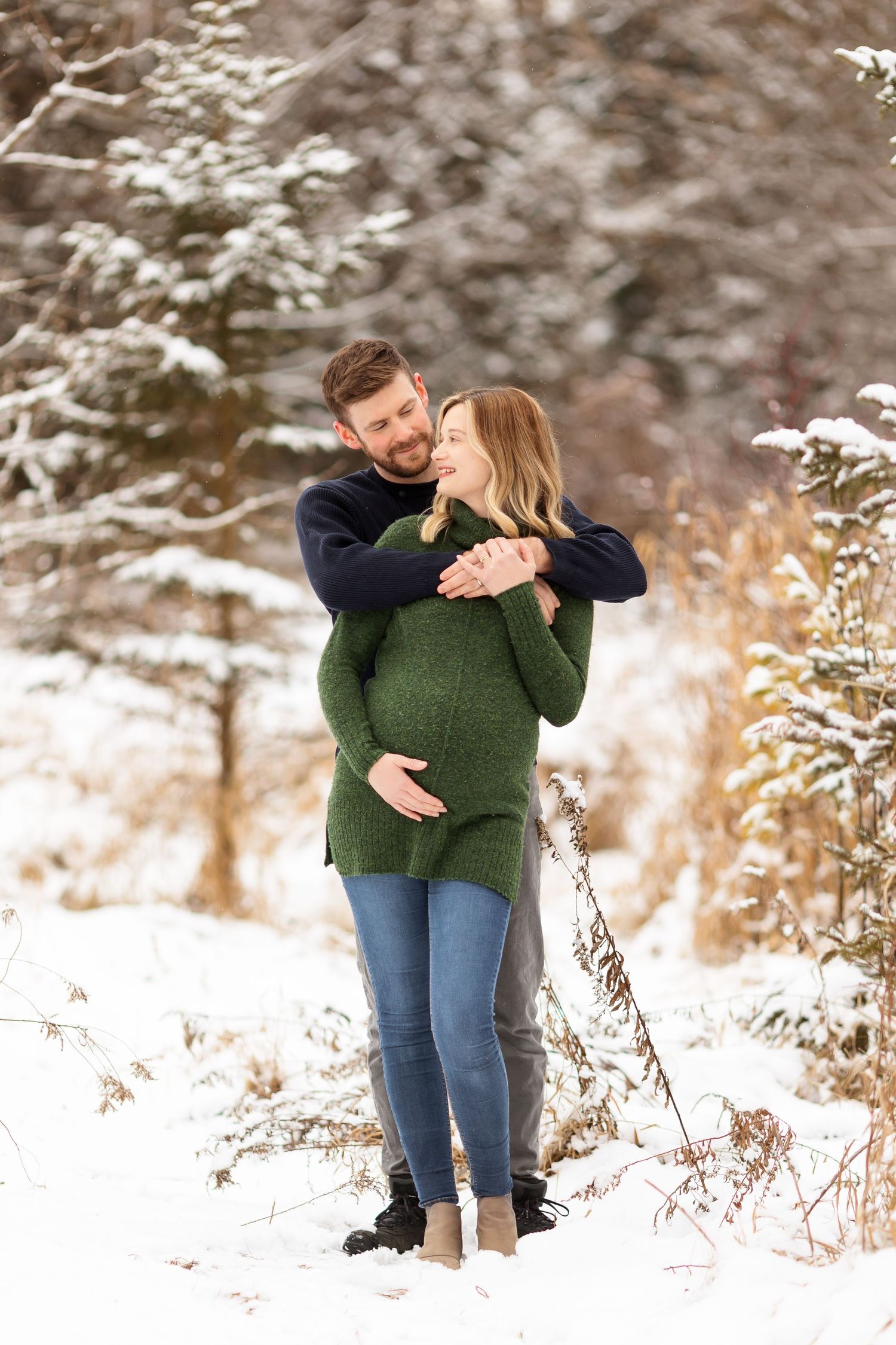 A tender moment between a couple during their winter maternity photoshoot.