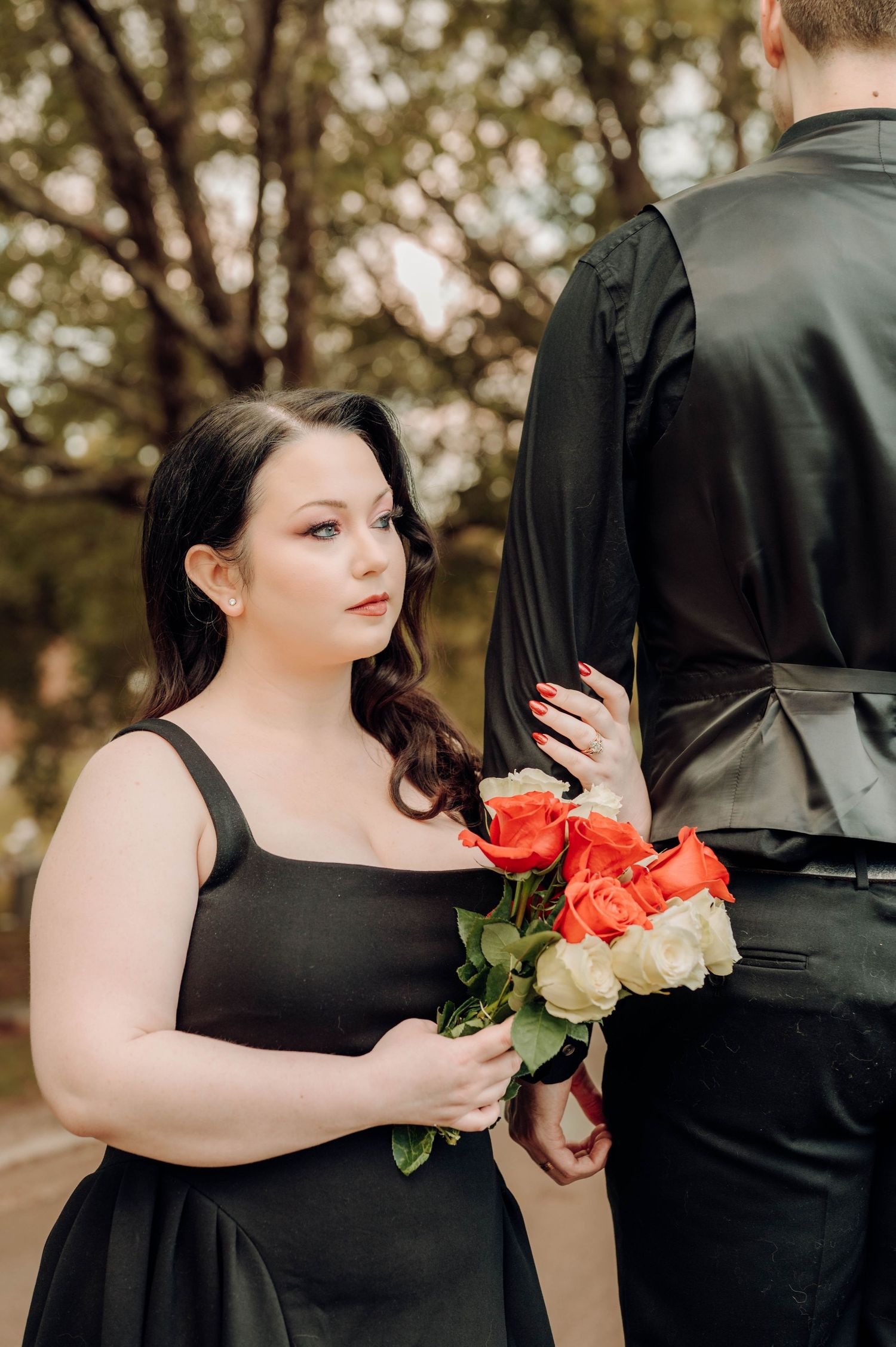 A series of wedding photos showing a person in a black dress holding vibrant red and white roses against a blurred outdoor backdrop.