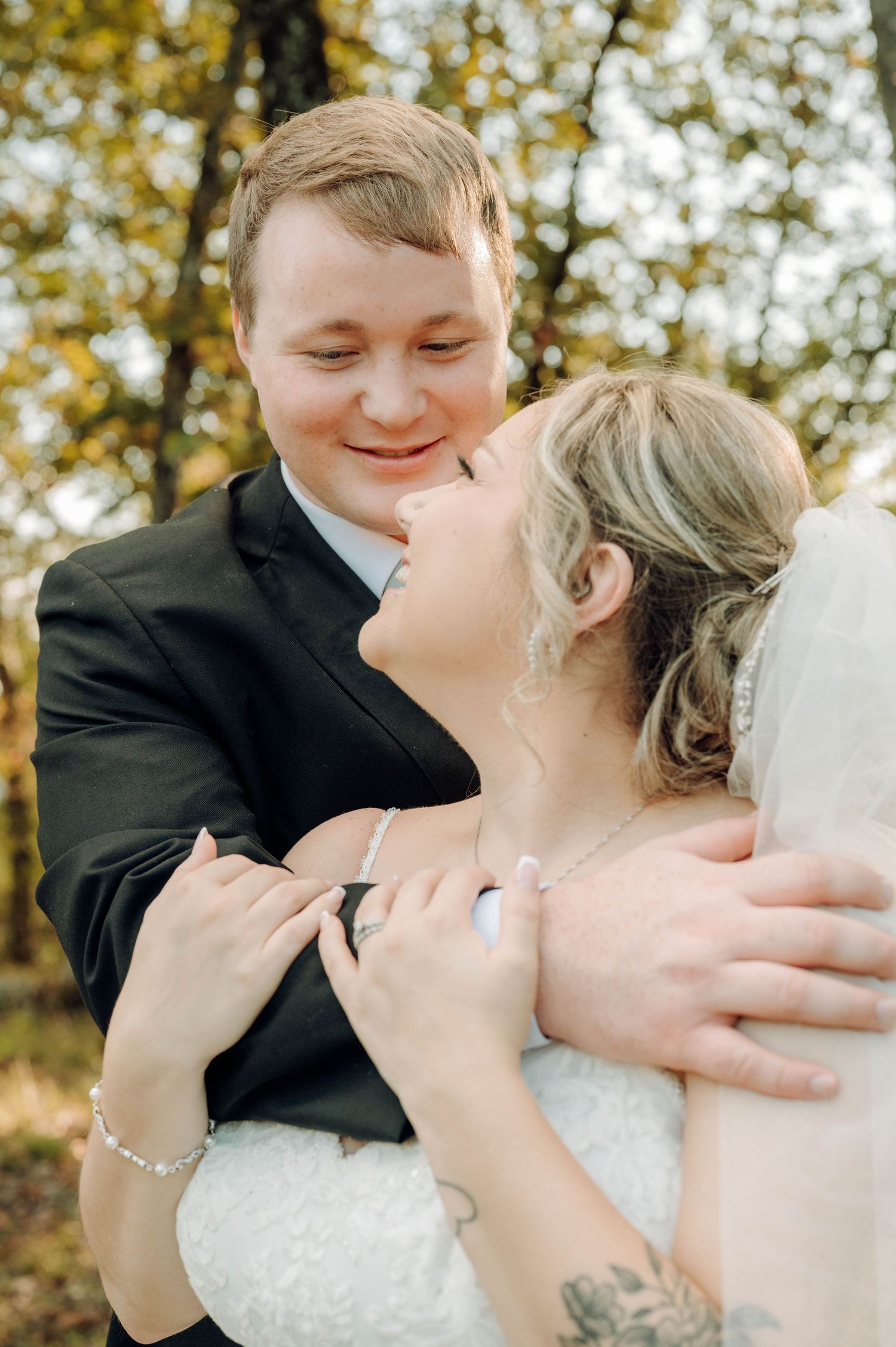 A romantic wedding sequence showing a couple sharing tender kisses in a sunlit autumn setting with golden foliage.