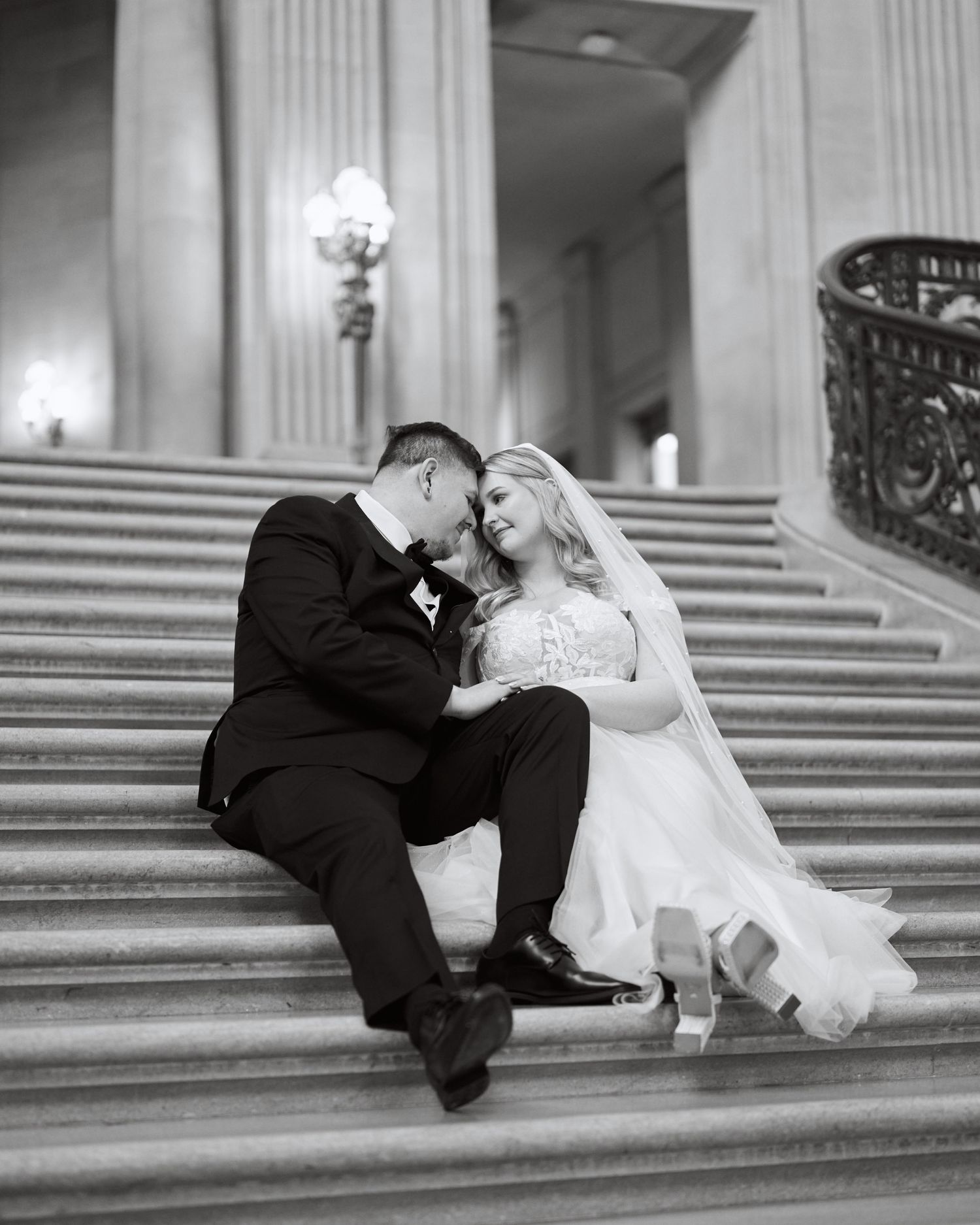 A couple sitting together on the stairs.