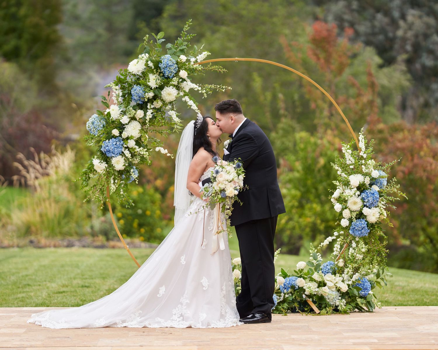 A bride and groom kissing at the altar.