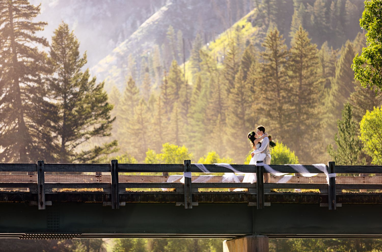 wedding couple on a bridge in the mountains captured by Full Flare Photography