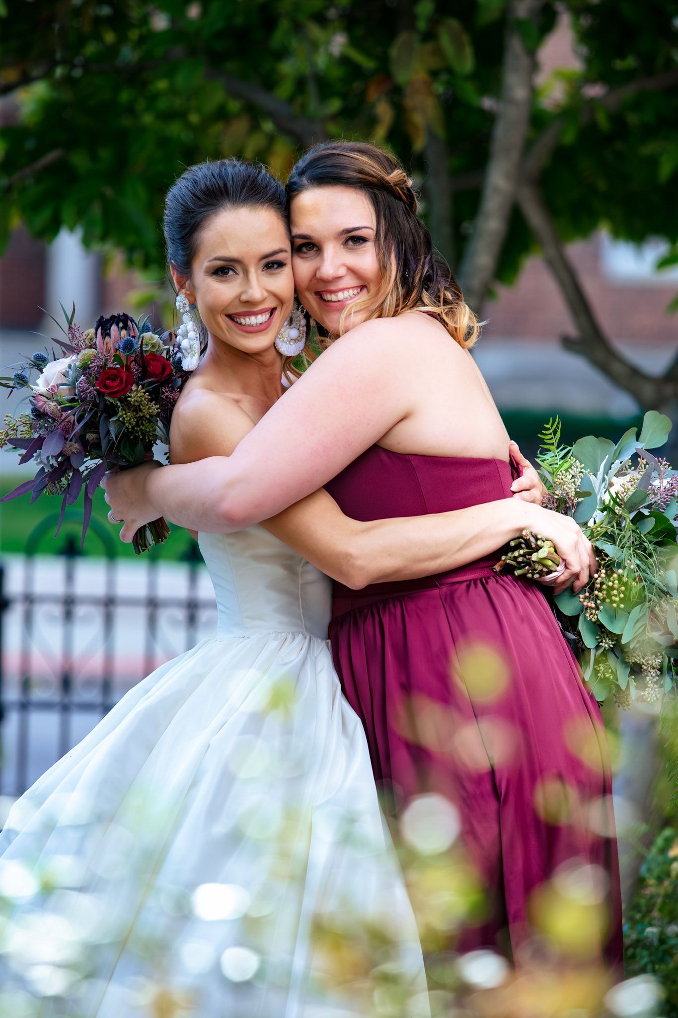 A bride and bridesmaid hugging