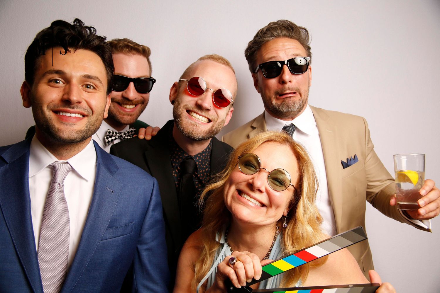 A group of friends pose for a photo booth picture at a wedding at DAC in downtown Detroit