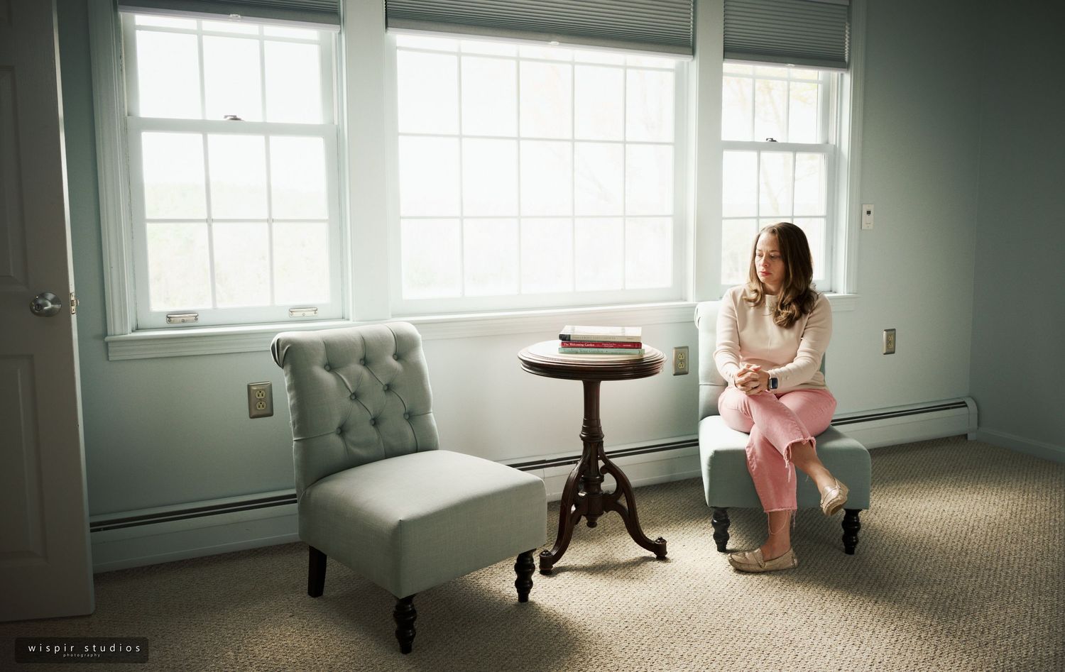 A series of four minimalist interior photos showing a window-lit room with tufted furniture and soft natural lighting.