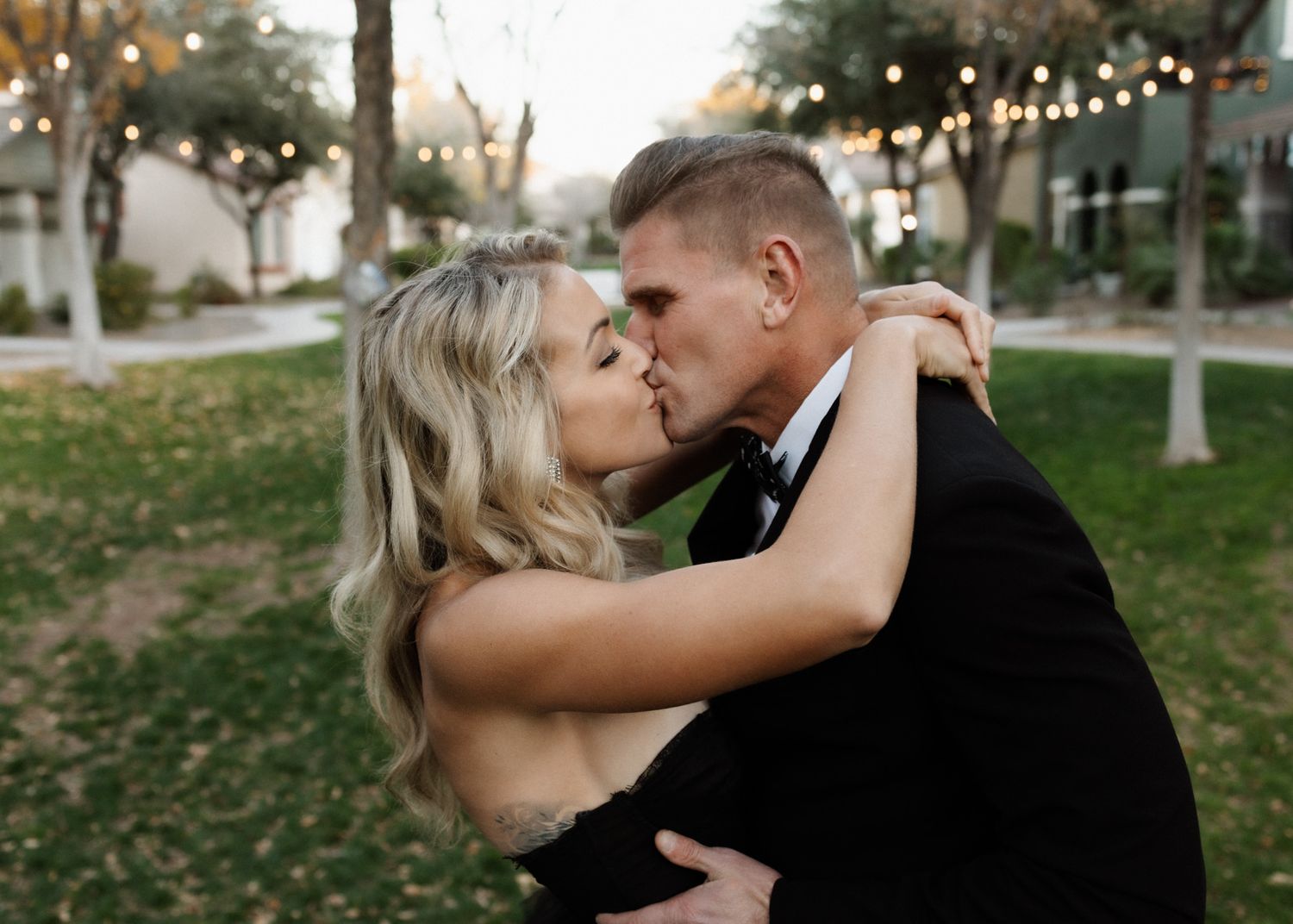 Romantic outdoor portrait of couple sharing an intimate moment at dusk.