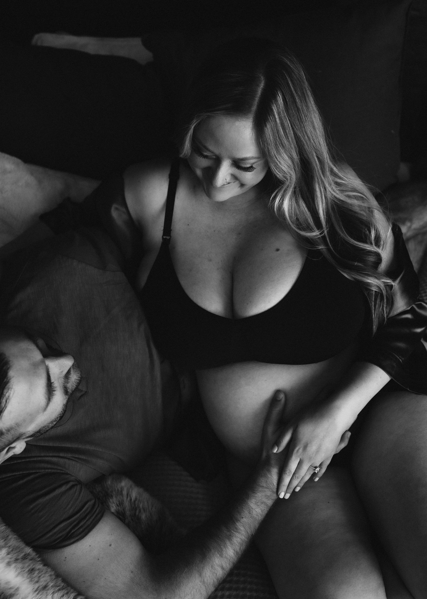 Intimate black and white maternity portrait showing expectant mother in loungewear.