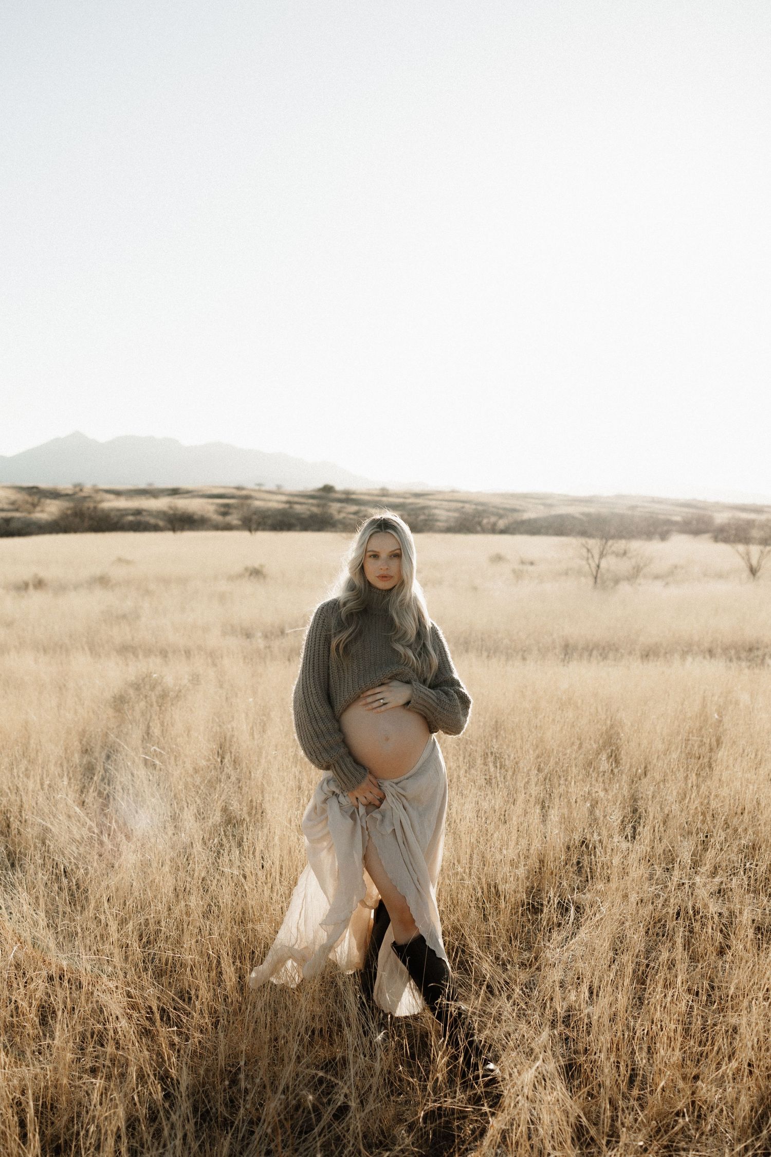 Series of images showing a person in casual clothing exploring a golden-hued field of tall grass during sunset.