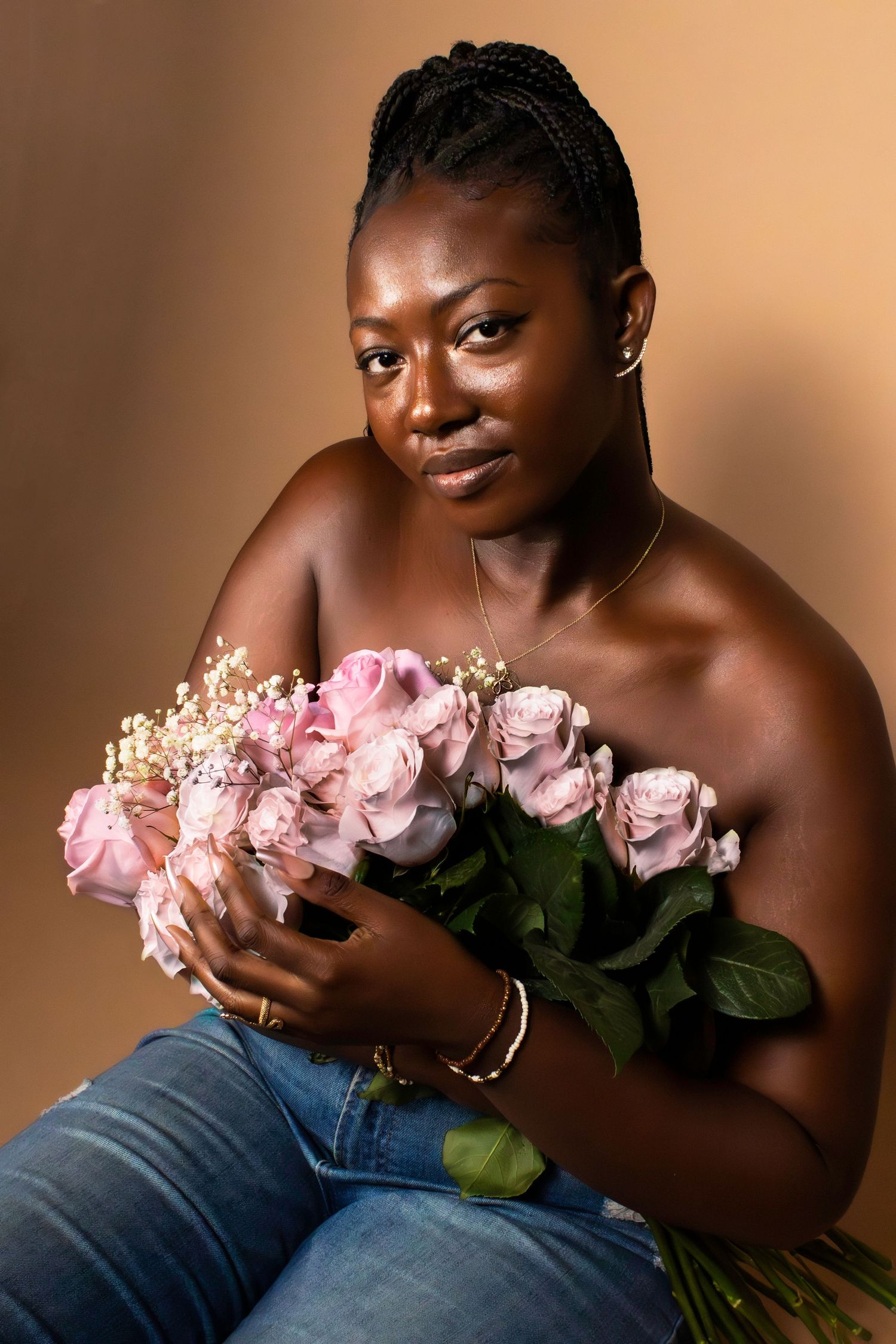 A tender moment captured with pink roses and elegant braided hairstyle.
