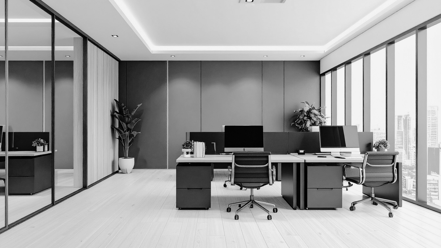 Modern minimalist office interior with gray walls, ergonomic chairs, dual monitor desks, and floor-to-ceiling windows.