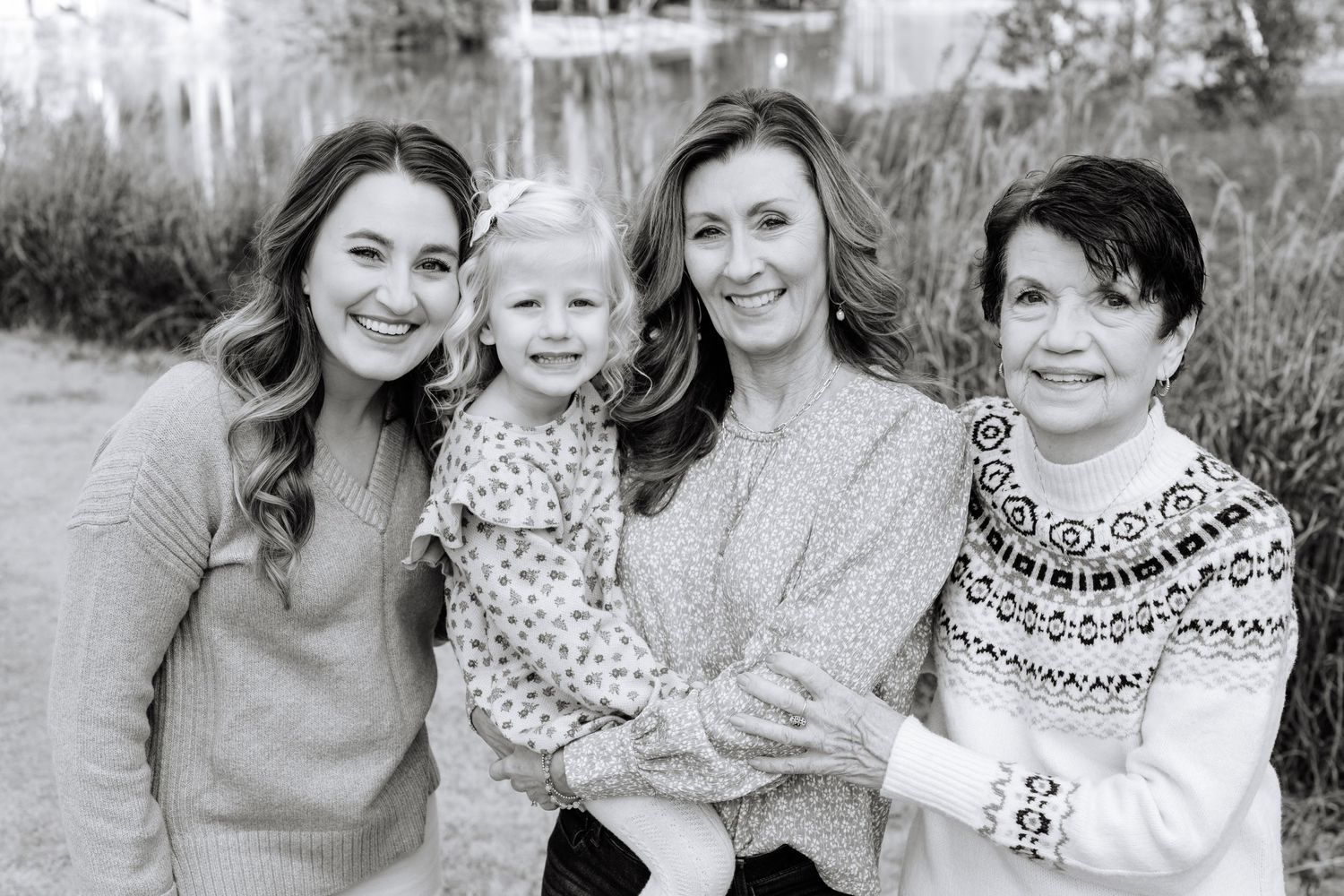 Multi-generational portrait of four people in cozy winter sweaters.