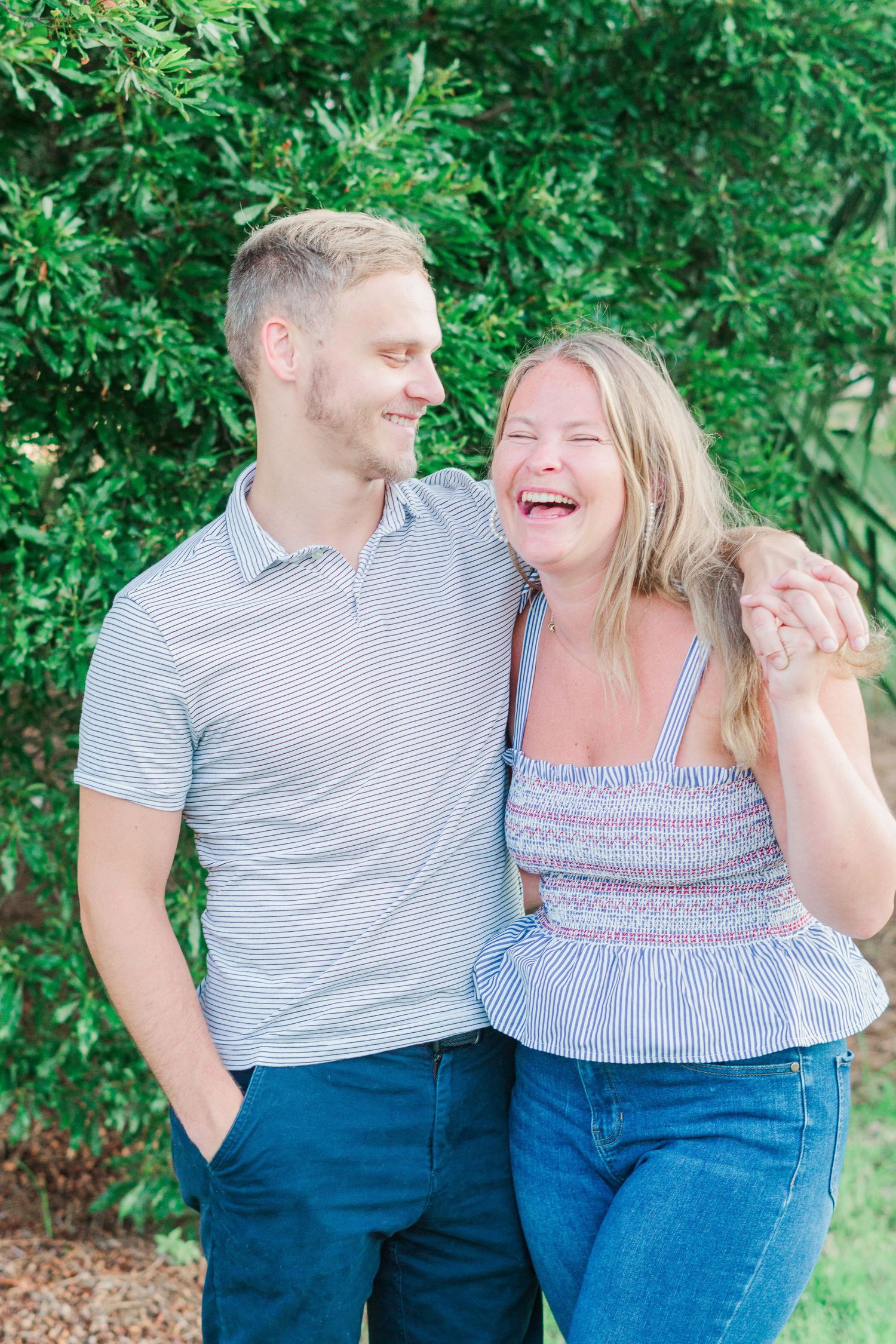 Couple sharing joyful moment while standing together outdoors.