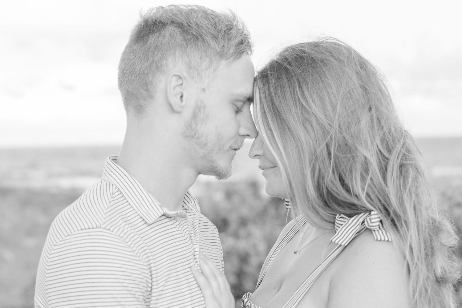 Close up of couple sharing intimate moment in soft black and white portrait.