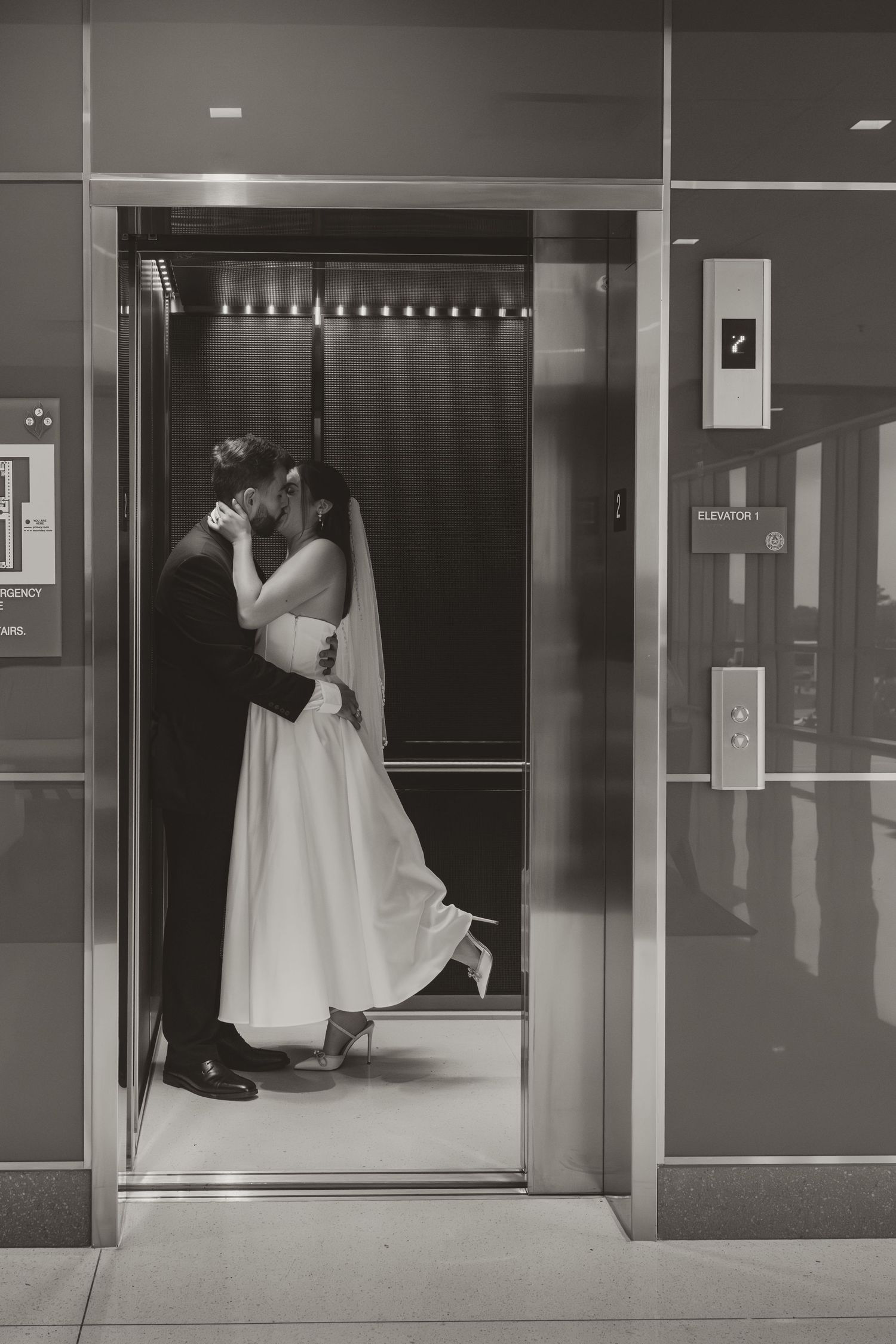 Black and white photos of a bride in a flowing white dress posing playfully in an elevator lobby. Wedding Photographer Fort Worth