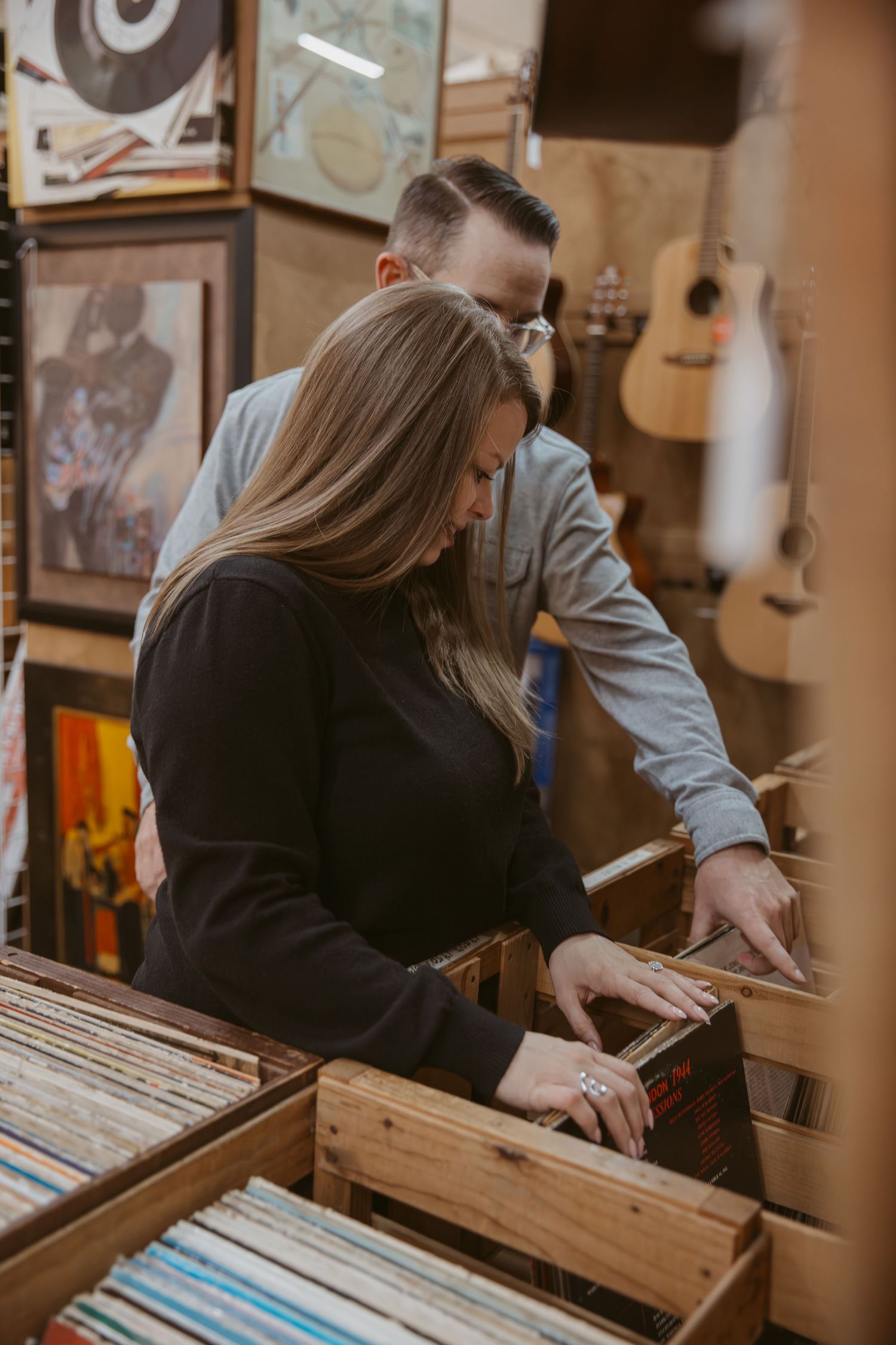 Browsing through vinyl records in wooden crates at a vintage record store.