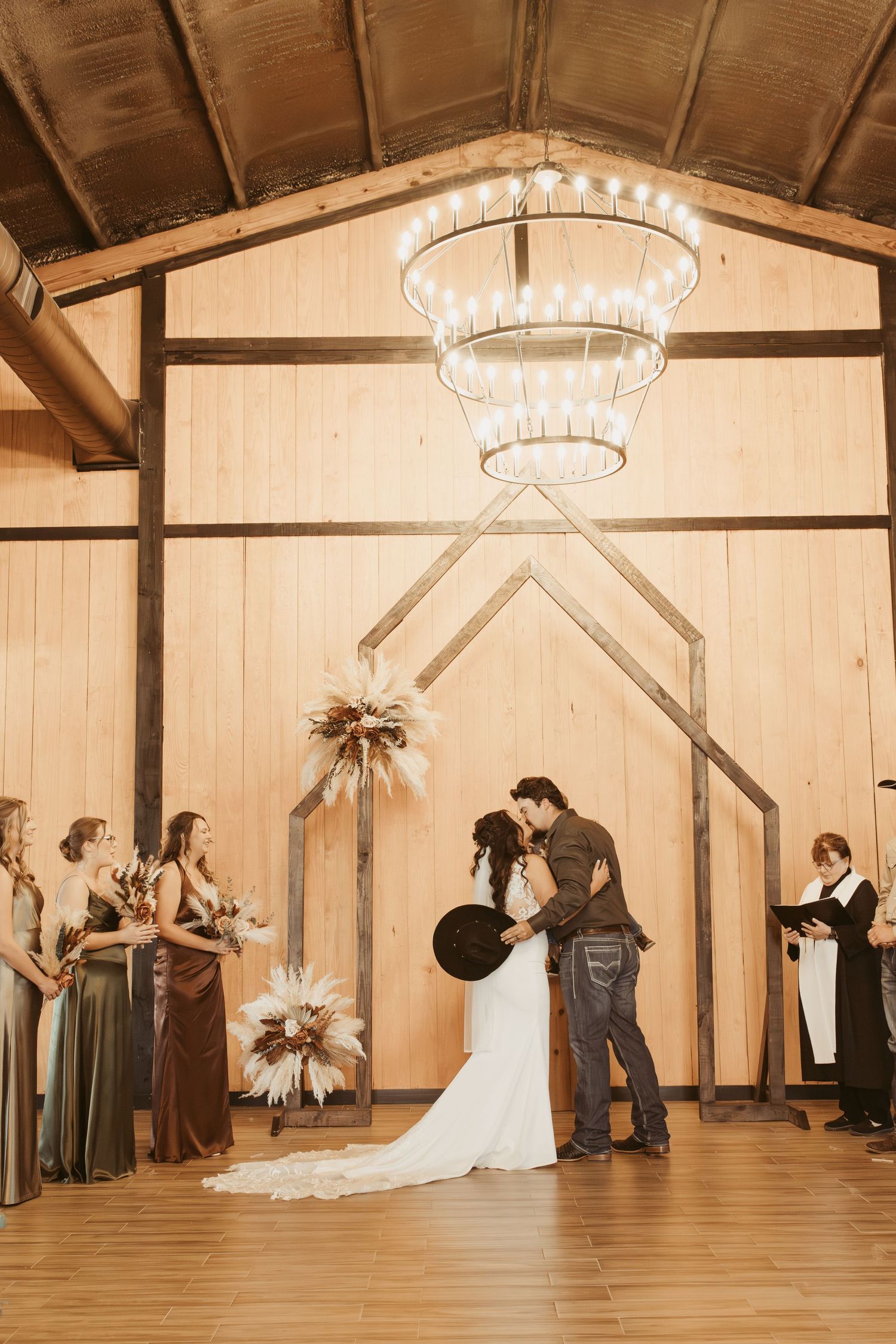 A series of sepia-toned photos capturing a first look wedding moment in a rustic barn setting. Wedding photographer DFW