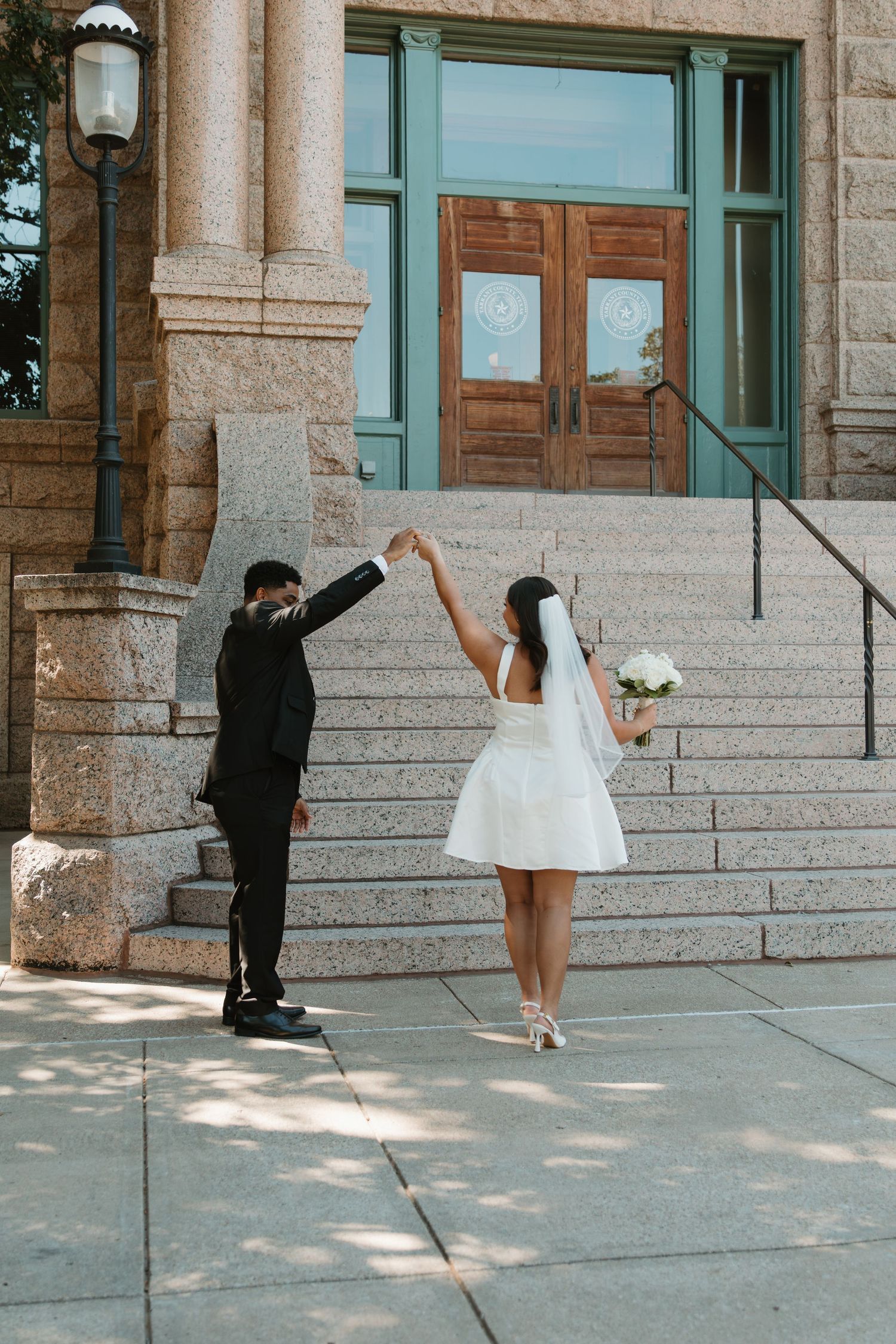 A series of wedding photos showing a couple posing on stone steps of a historic building. Wedding Photographer DFW