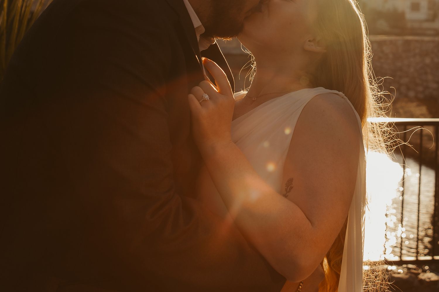 A silhouetted figure stands against a warm glowing sunset creating a dreamy backlit effect.