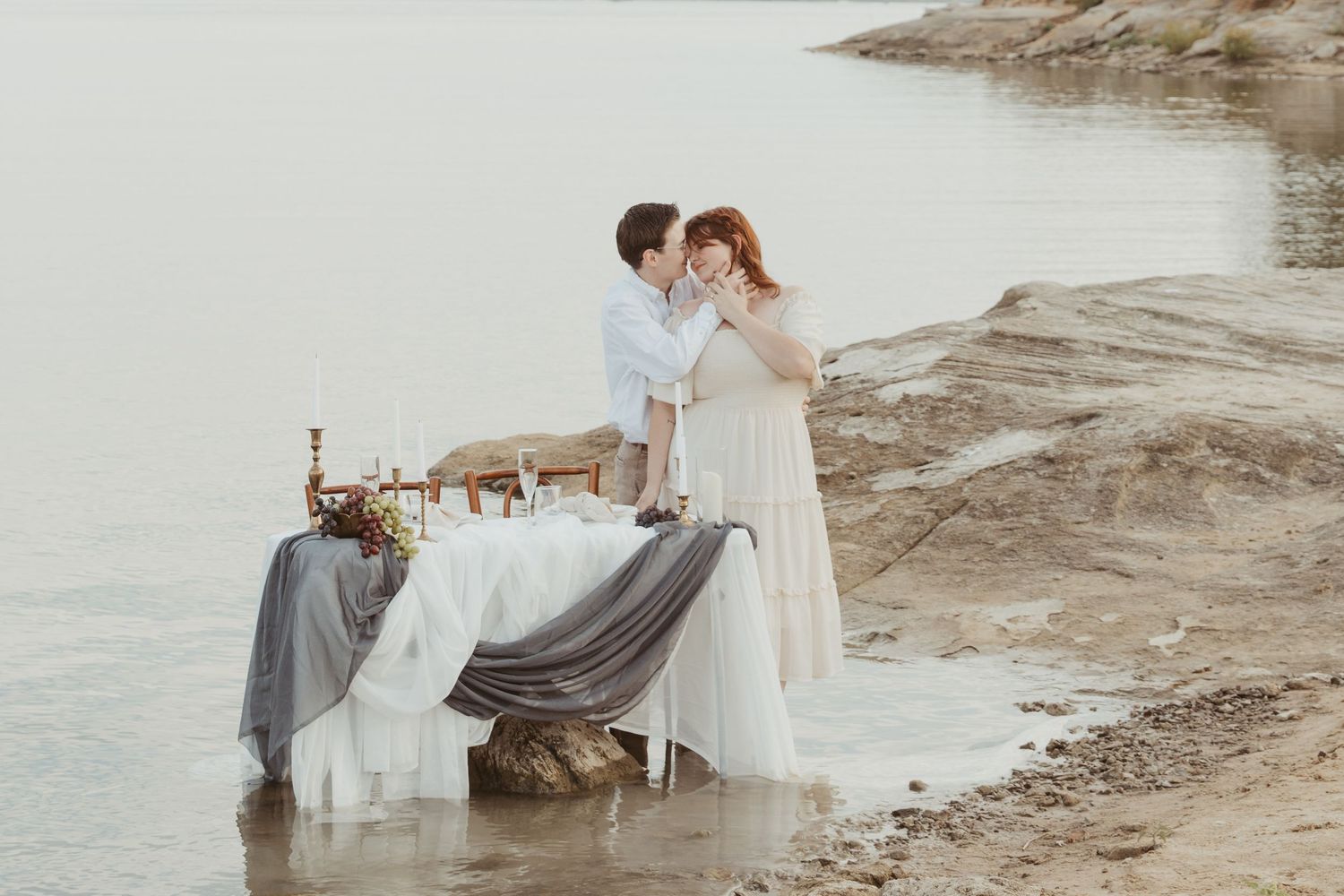 Waterfront wedding reception setup with draped linens and elegant table decor.