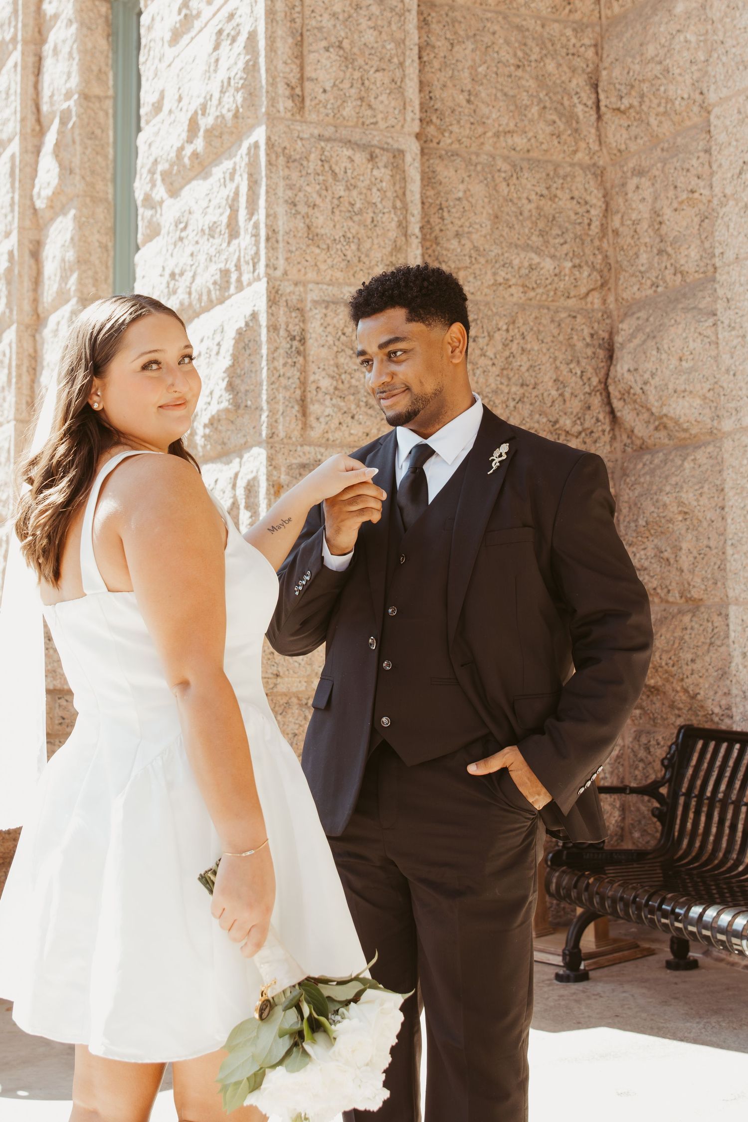 A series of candid wedding photos showing a couple sharing emotional moments against a stone wall backdrop. Wedding Photographer DFW