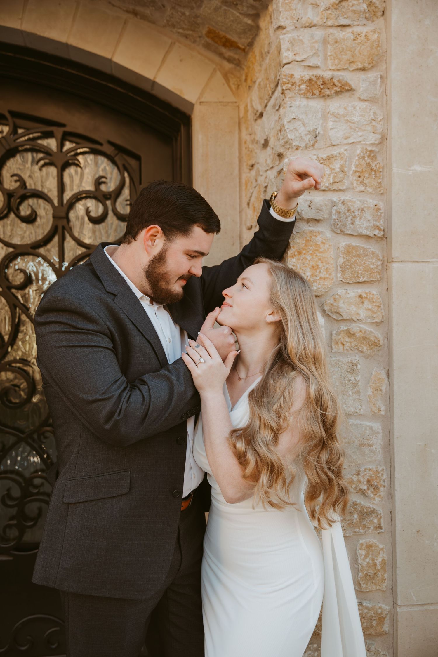 Romantic wedding couple shares intimate moments in a series of photos against a rustic stone wall backdrop.