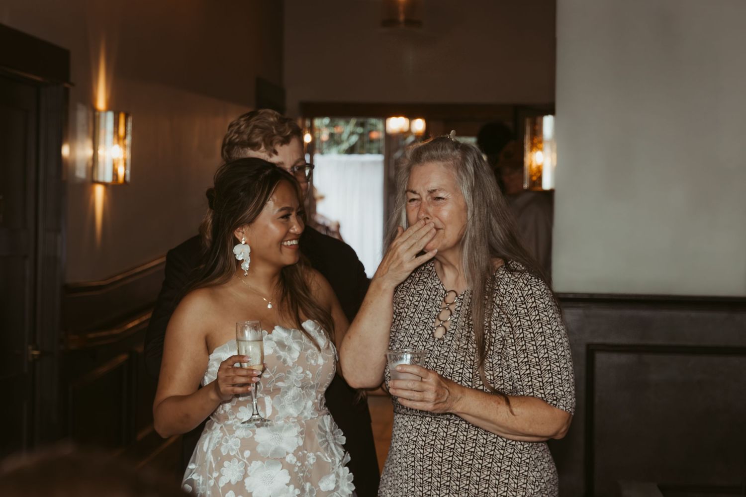 Intimate indoor wedding reception with festive lighting and joyful celebrations.