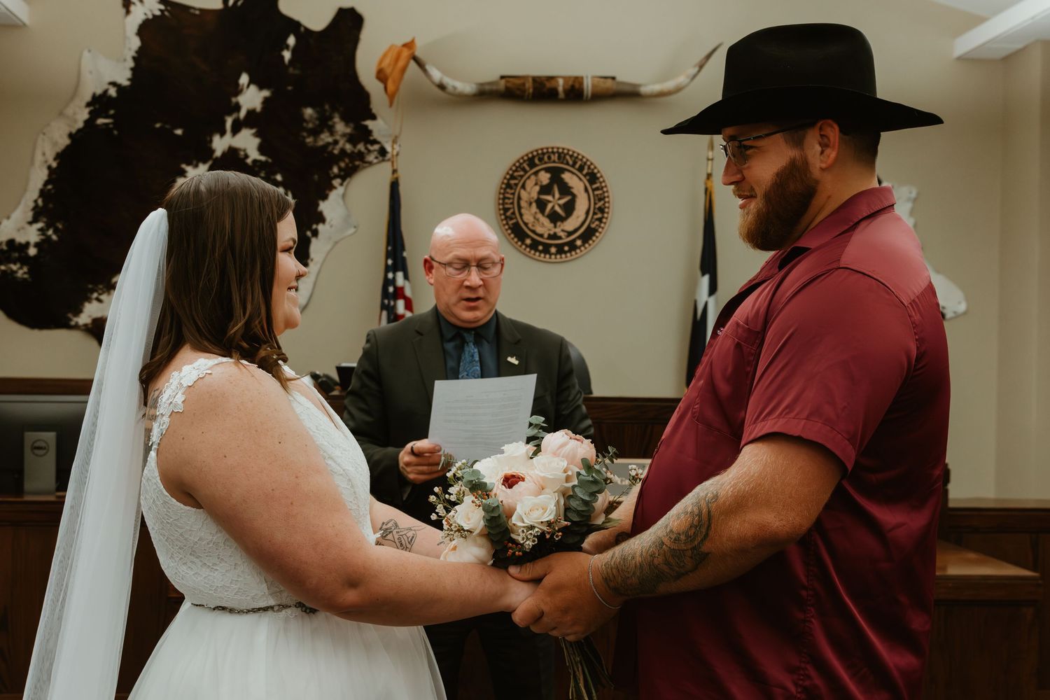 A wedding ceremony in progress with traditional dress and western style details.