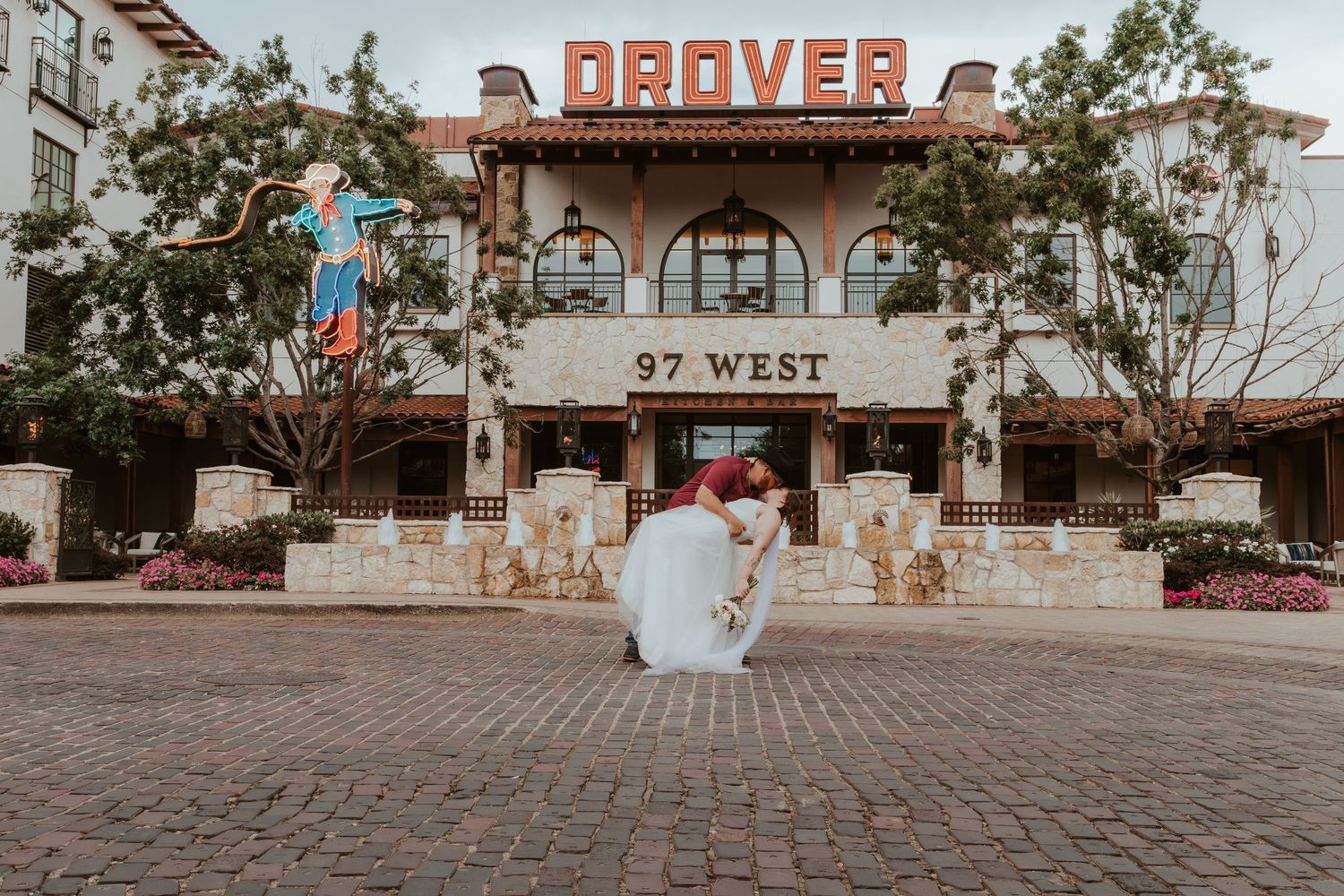Romantic wedding photo taken at dusk in front of the Denver 97 West building entrance.