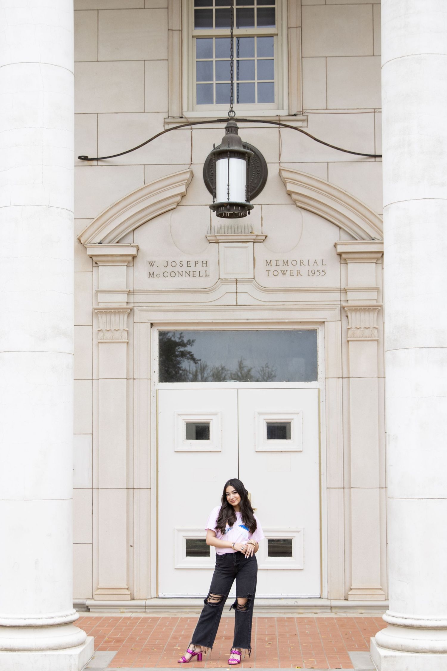 A casual outfit captured in front of the W. Joseph McDonald Memorial building's white doors and columns.