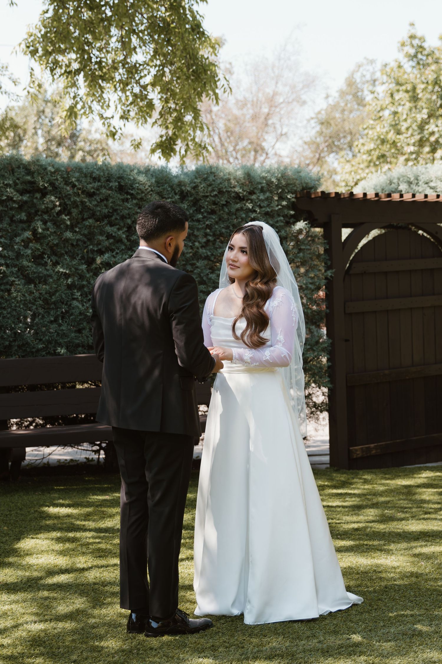 A romantic first look moment between newlyweds in a garden setting during a spring wedding ceremony.