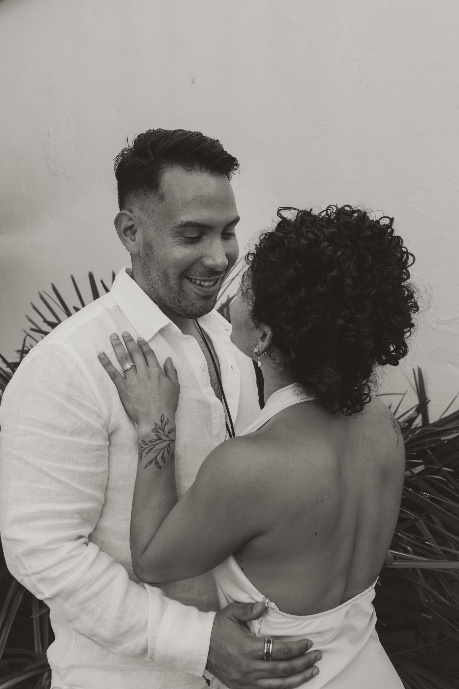 A couple shares intimate moments in a sequence of romantic black and white wedding photos.