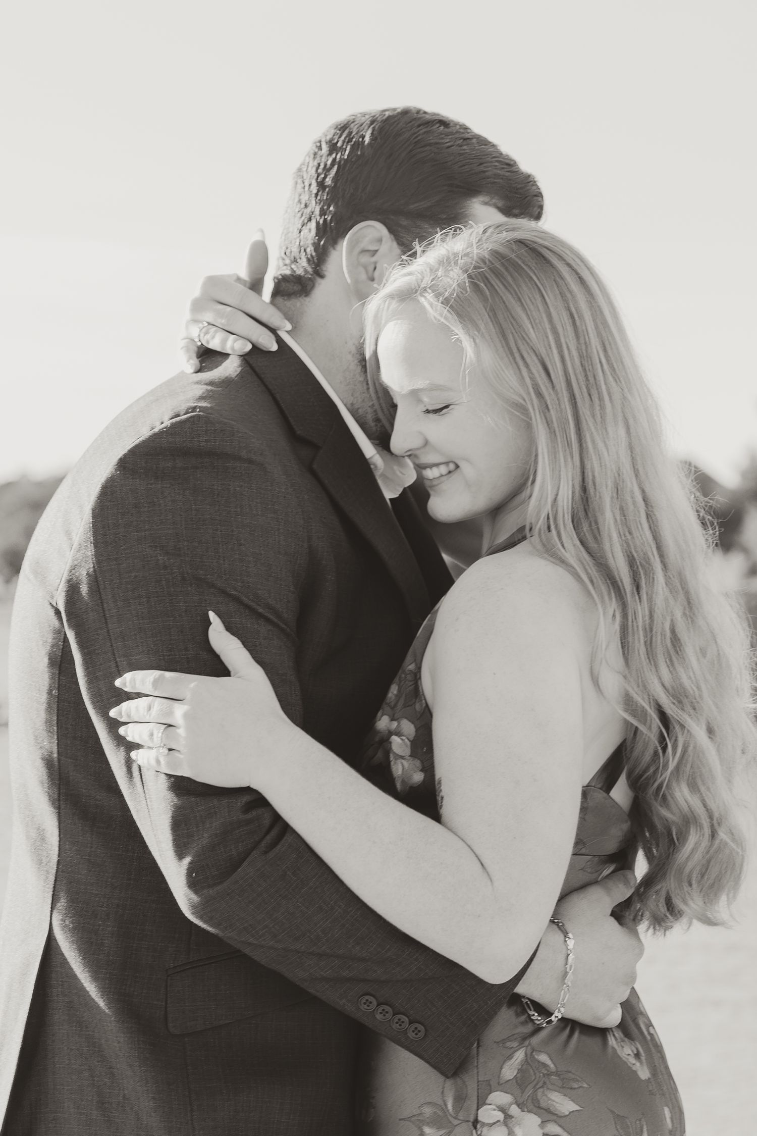 A romantic black and white photo series showing a couple embracing and sharing intimate moments together.