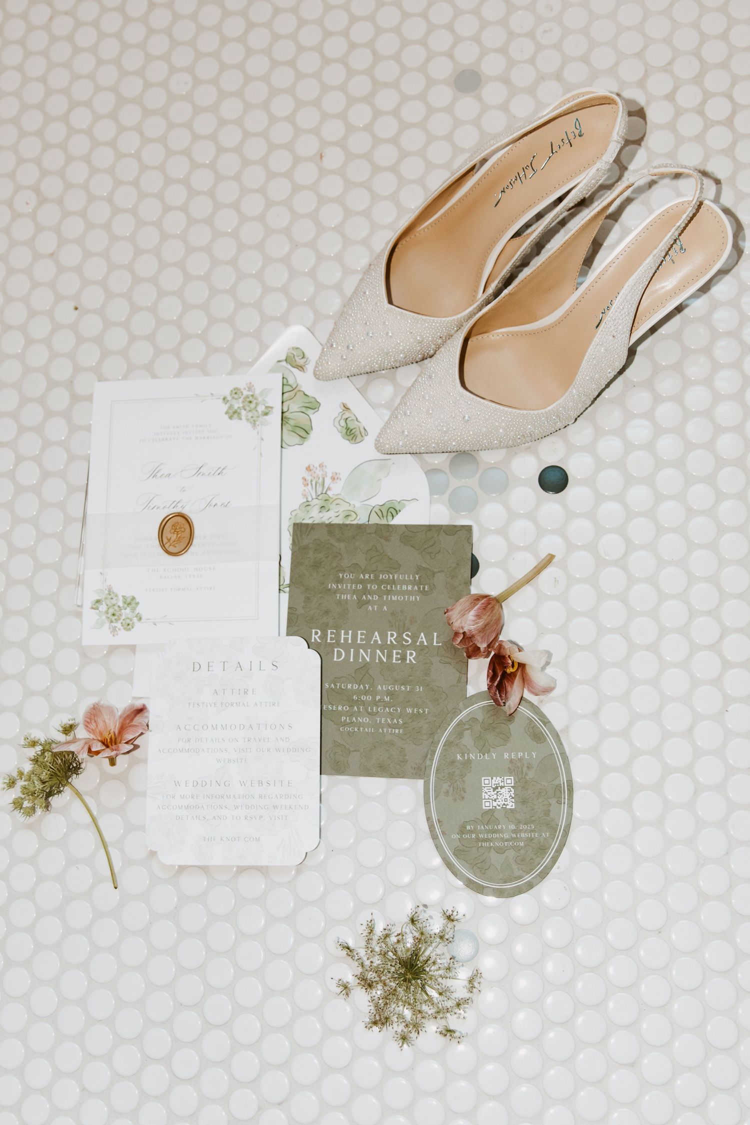 Elegant wedding flat lay with sage green rehearsal dinner invitations and glitter heels.