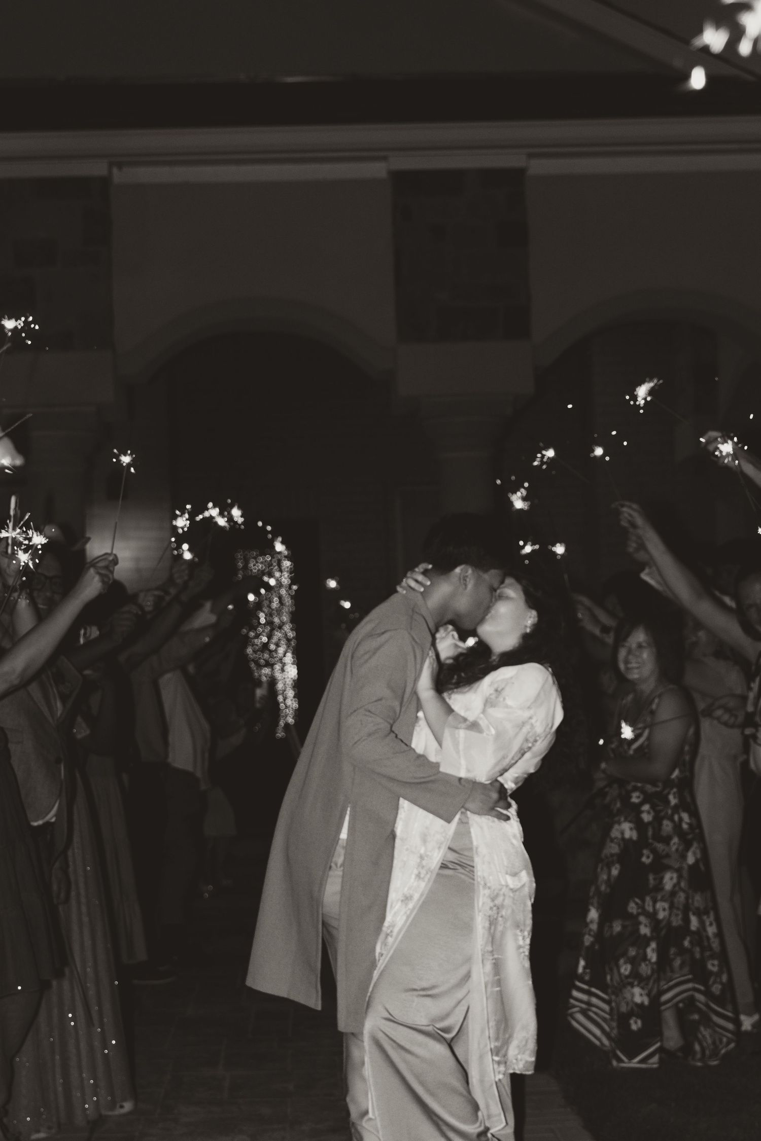 Wedding reception dance floor scene with sparklers creating a magical nighttime atmosphere.