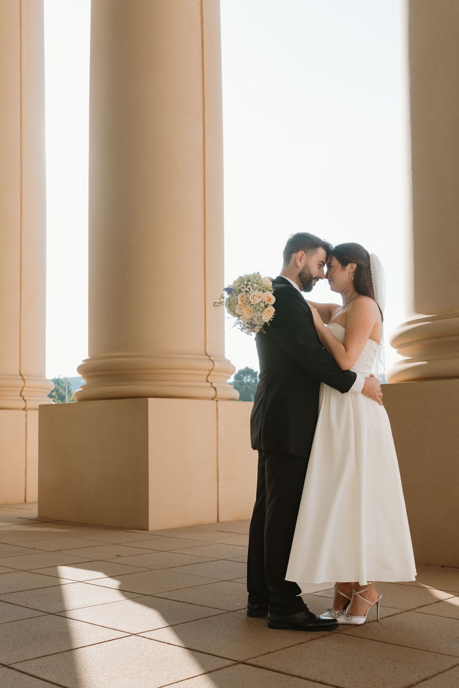 A wedding ceremony sequence captured between elegant columns with warm lighting and tiled floors. Wedding Photographer Fort Worth
