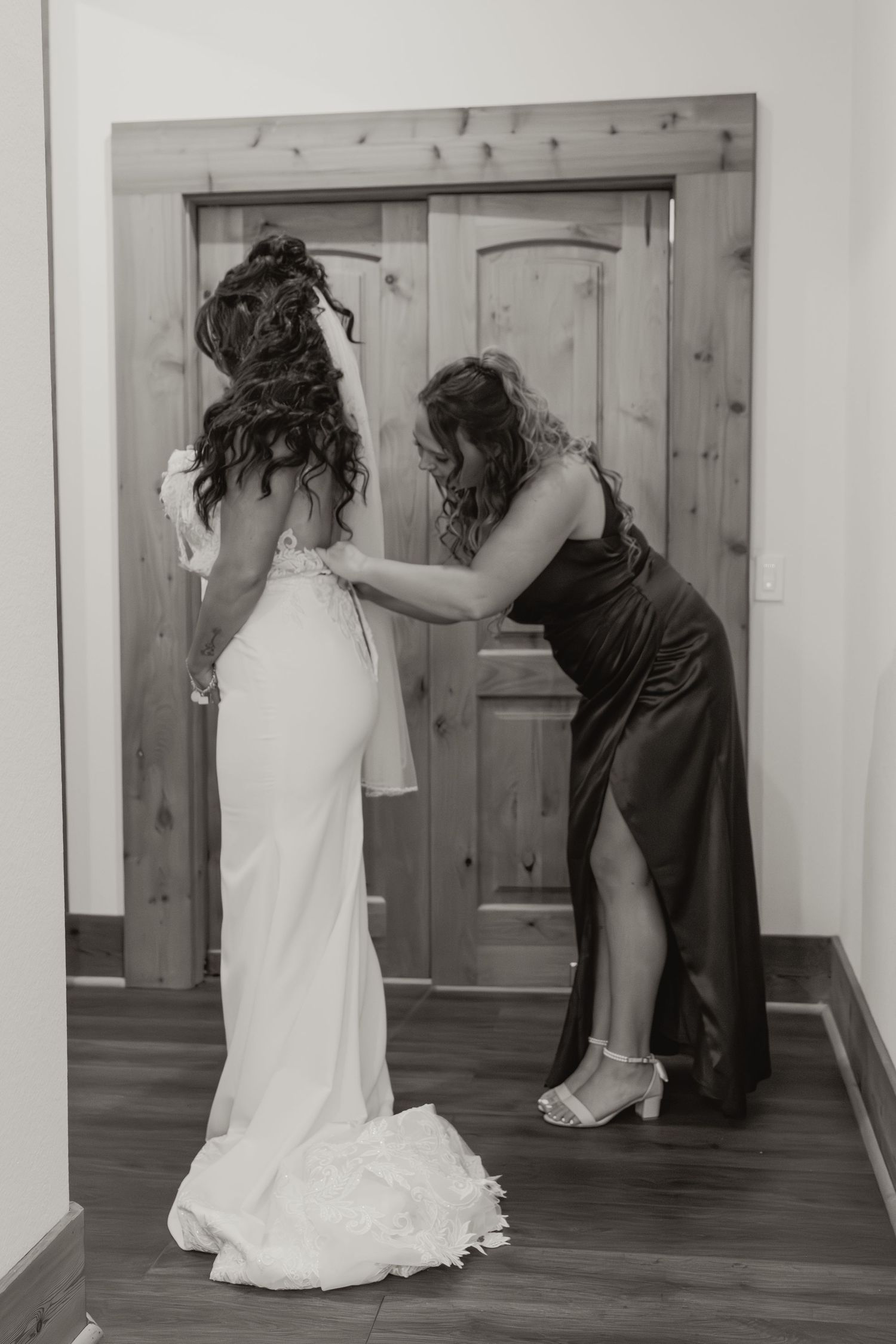 A series of black and white photos showing a person in a white dress and a dog interacting near a wooden door. Wedding photographer DFW