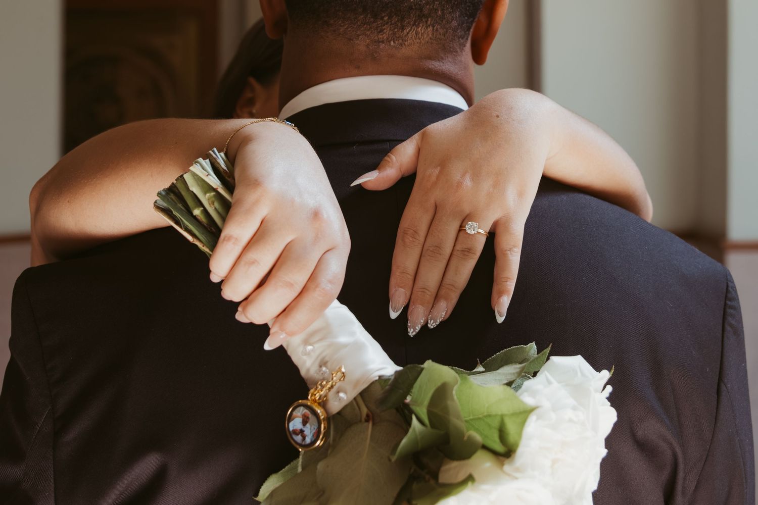 A couple exchanges rings during an intimate wedding ceremony with hands held together in a tender moment. Wedding Photographer DFW