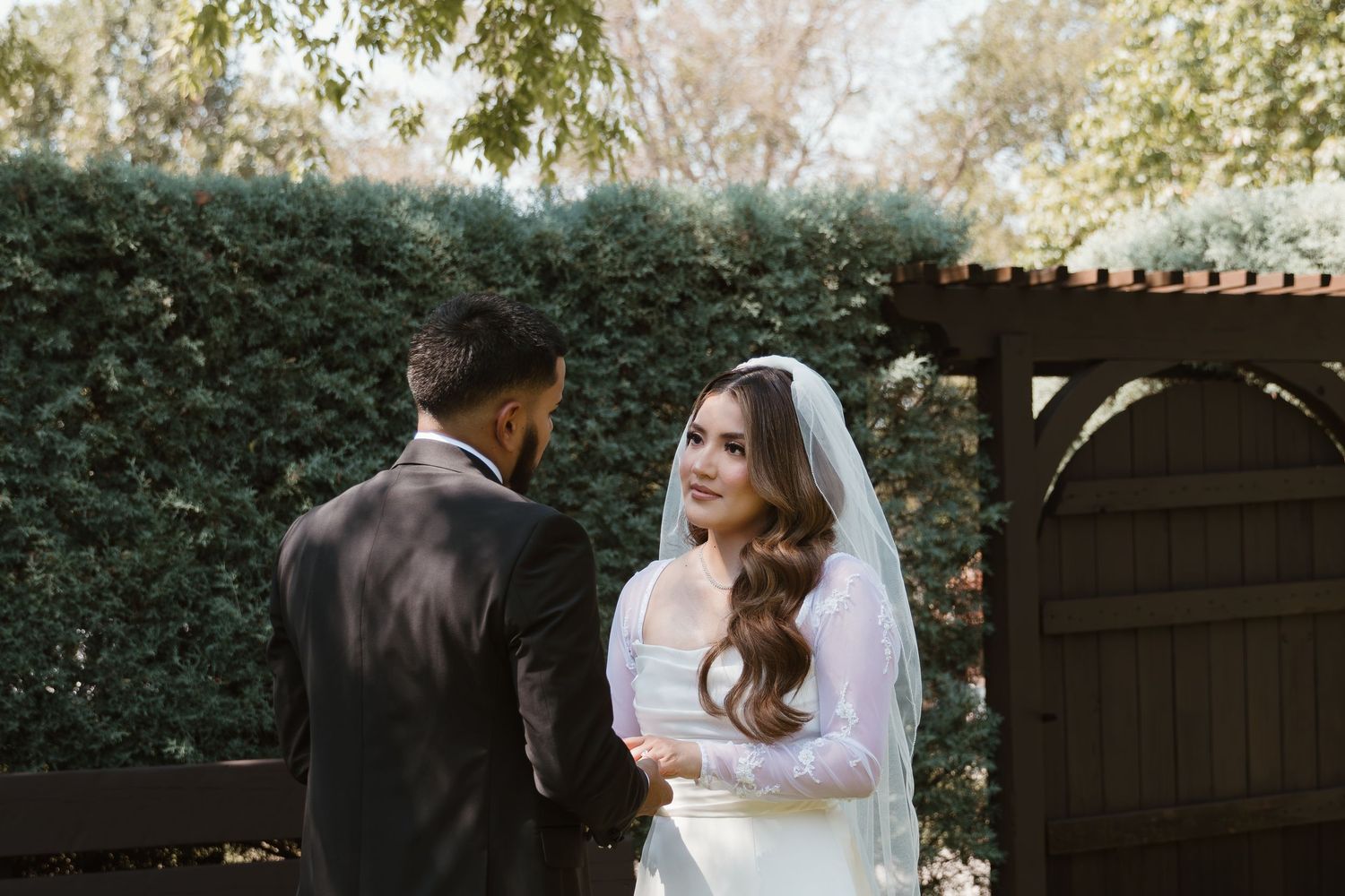 A romantic wedding photoshoot sequence showing tender moments between a bride and groom in an outdoor garden setting. Wedding Photographer D