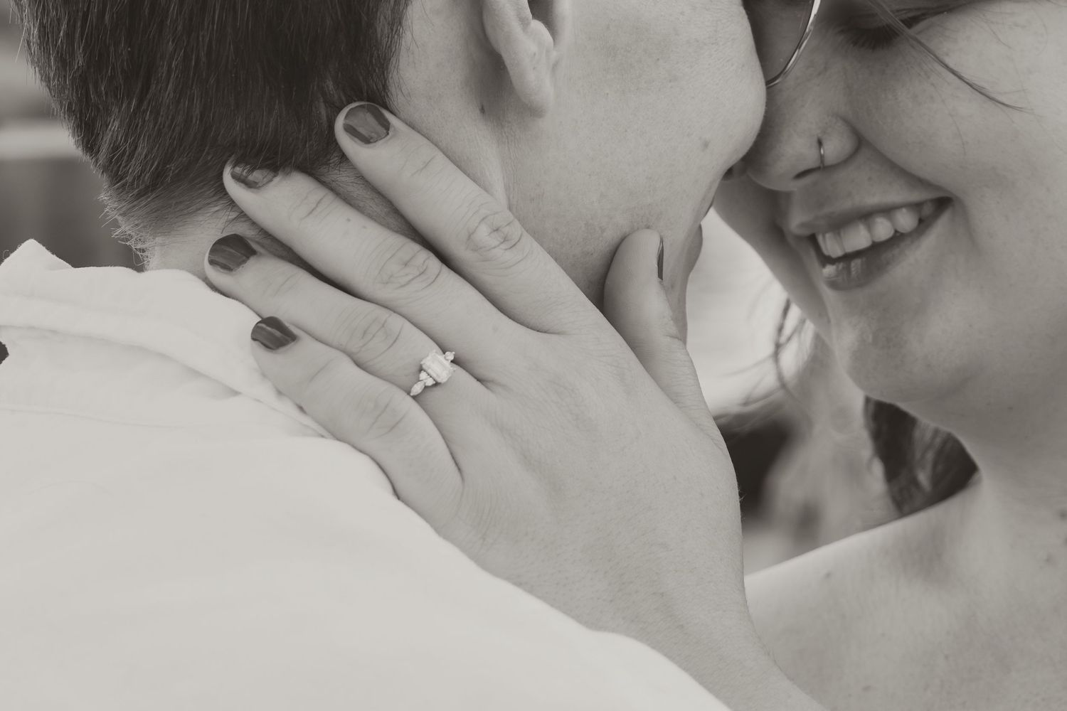 Close up of tender embrace showing hands and genuine emotion.