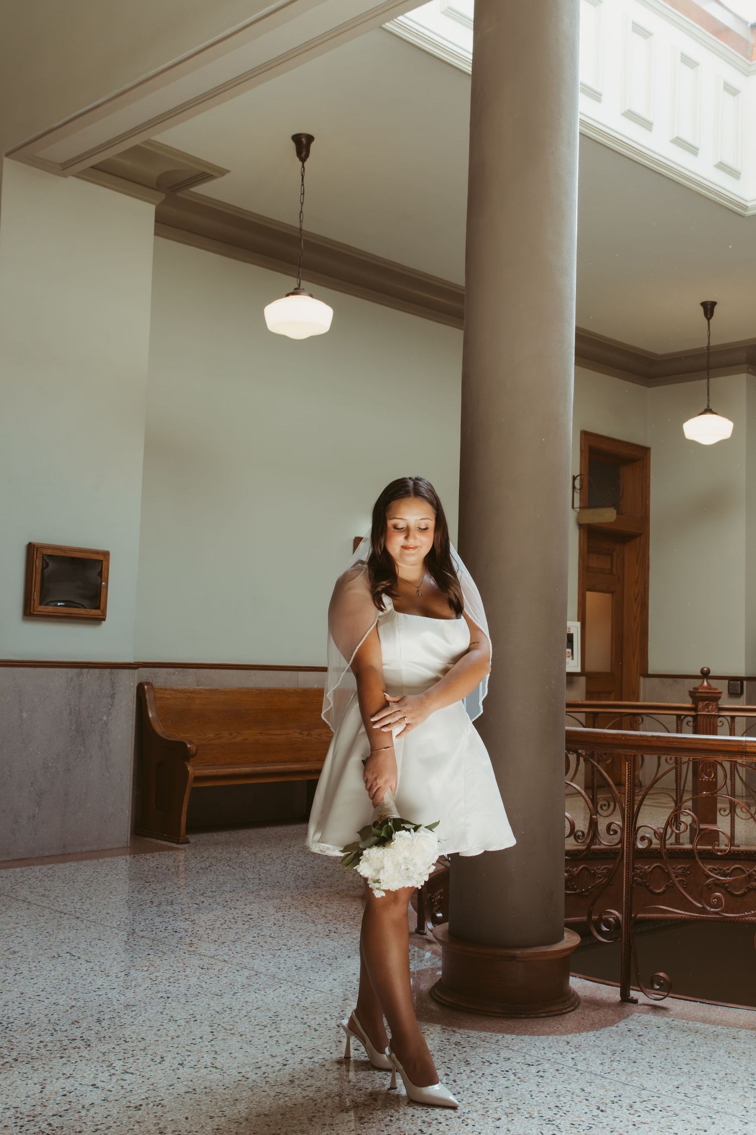 Elegant indoor photoshoot with white dress and formal attire against marble columns. Wedding Photographer DFW