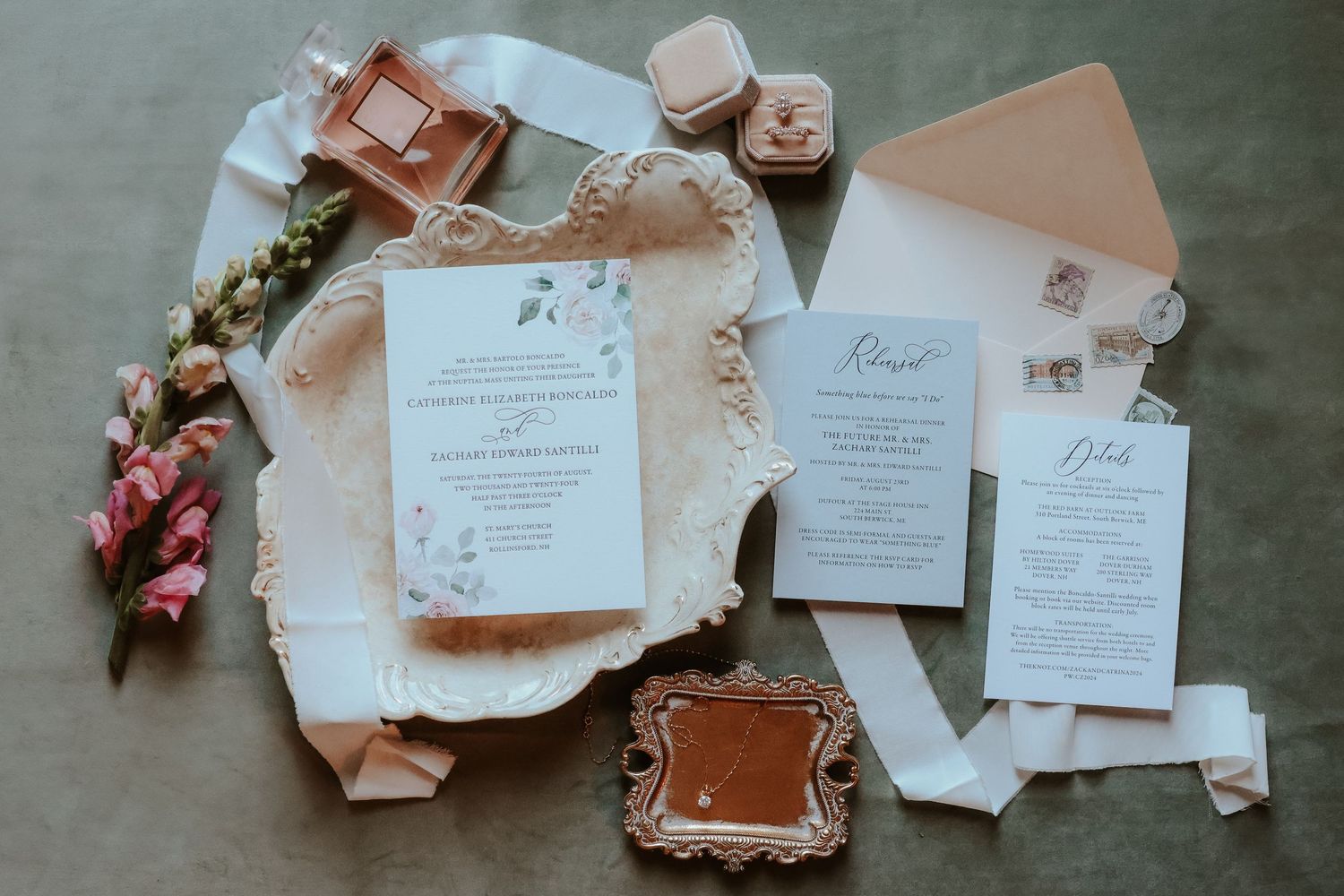 Elegant wedding stationery suite in soft white and blush tones with vintage stamps and floral accents on textured paper.