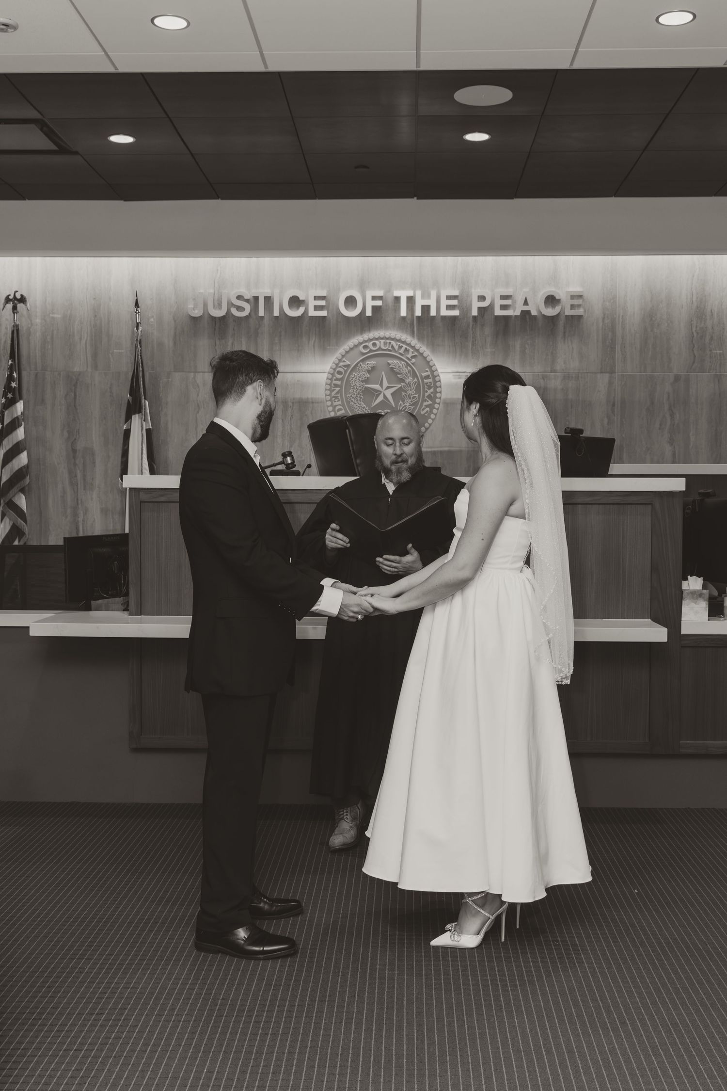 A sequence of black and white photos showing a wedding ceremony taking place at a Justice of the Peace office. Wedding Photographer Fort Wor
