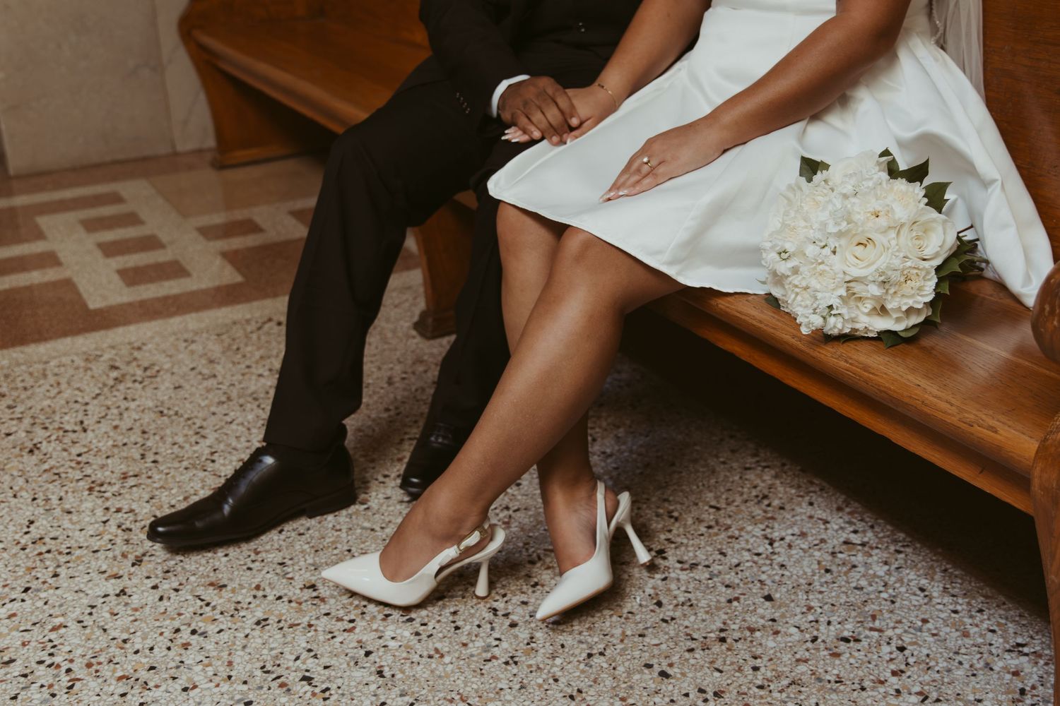 Close-up of formal shoes and white dress on speckled floor. Wedding Photographer DFW