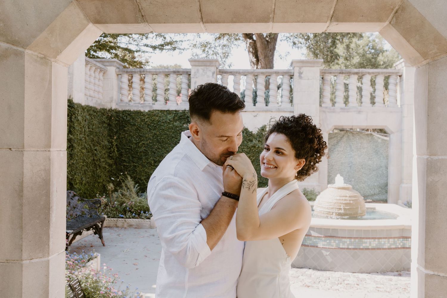 Newlywed couple shares a romantic dance together on an elegant stone patio during their wedding celebration. Wedding photographer DFW